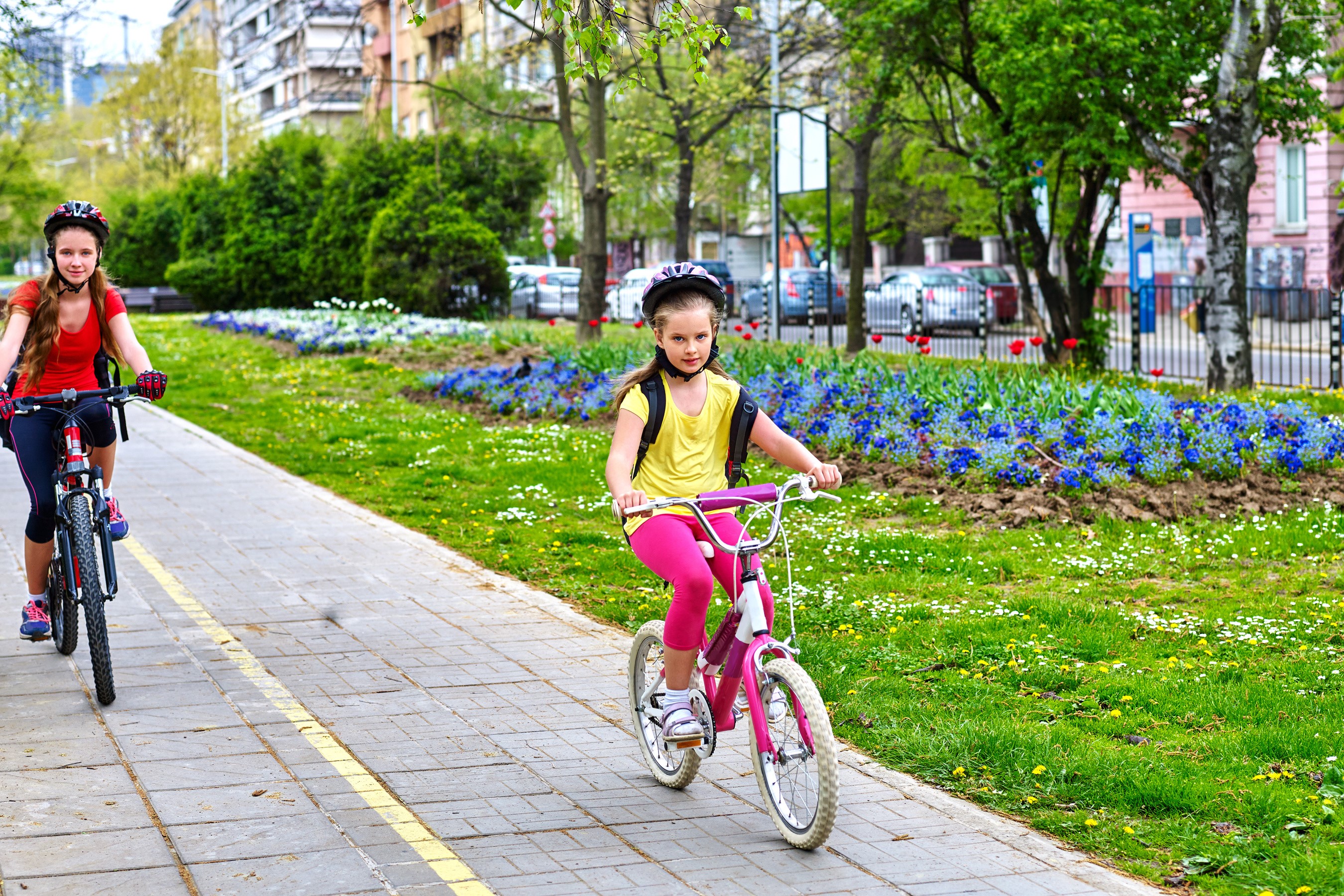 Two girls riding bicycles on a path HD Wallpaper