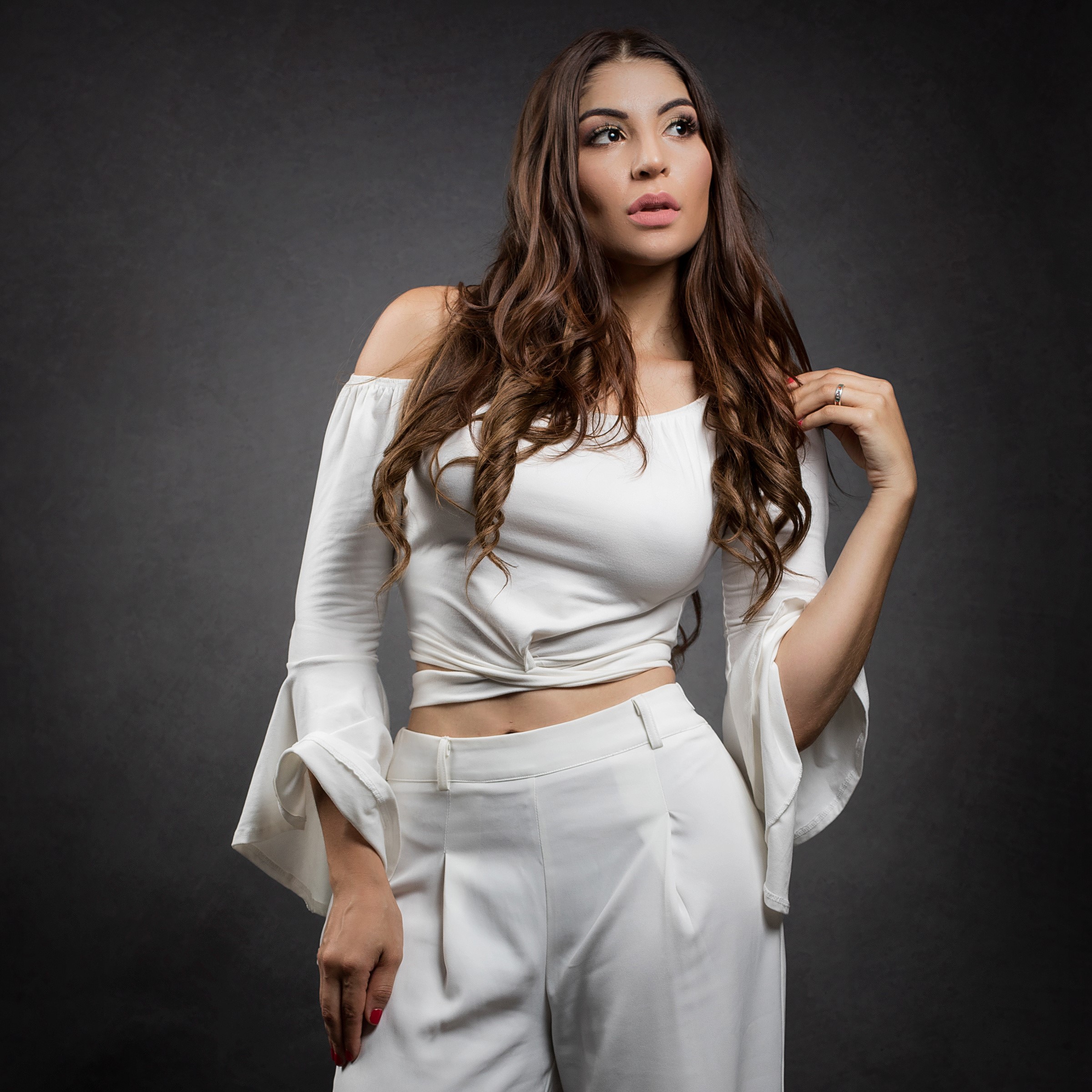 Priscila with brown hair wearing white blouse and trousers HD Wallpaper