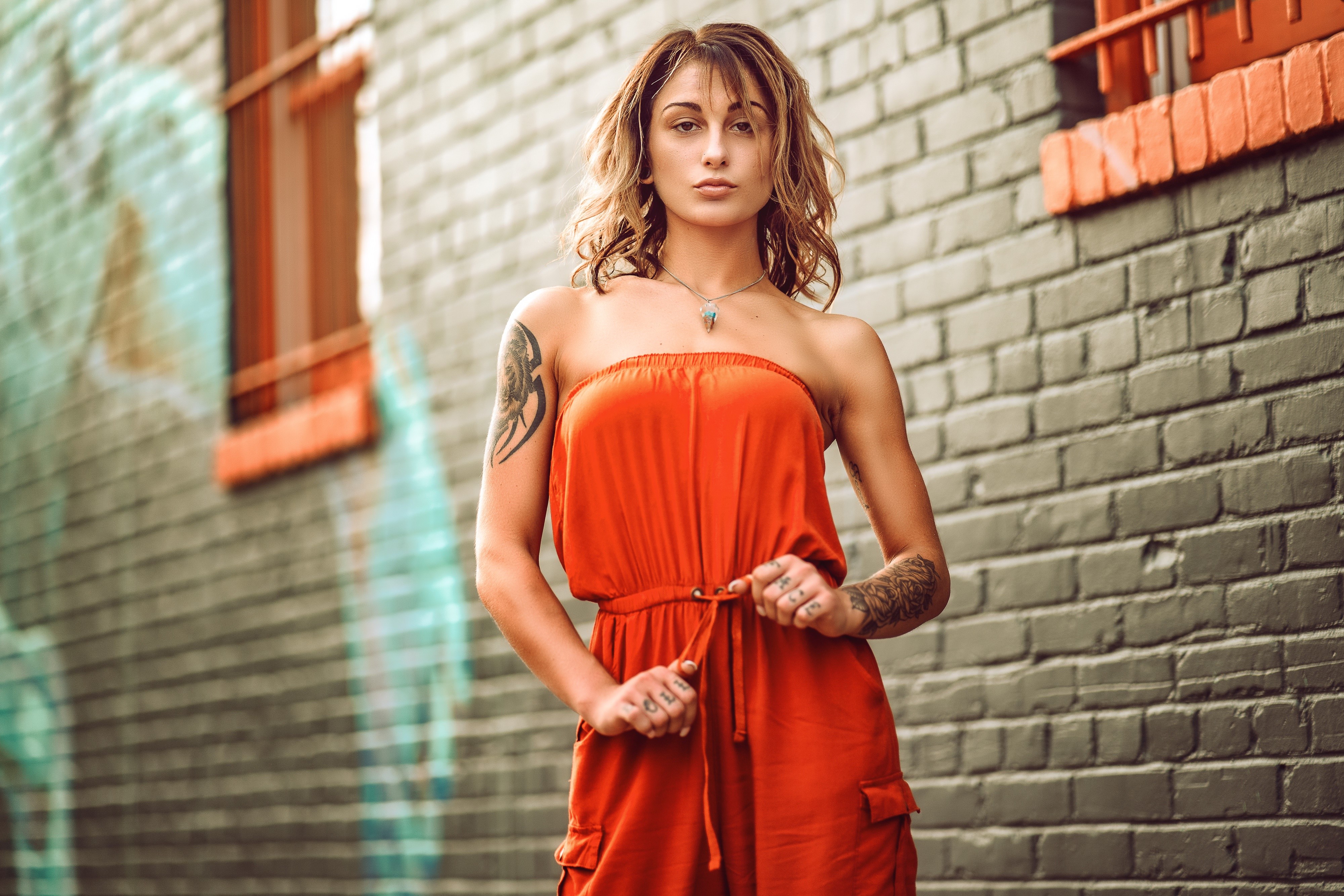 Woman in orange dress with tattoos HD Wallpaper