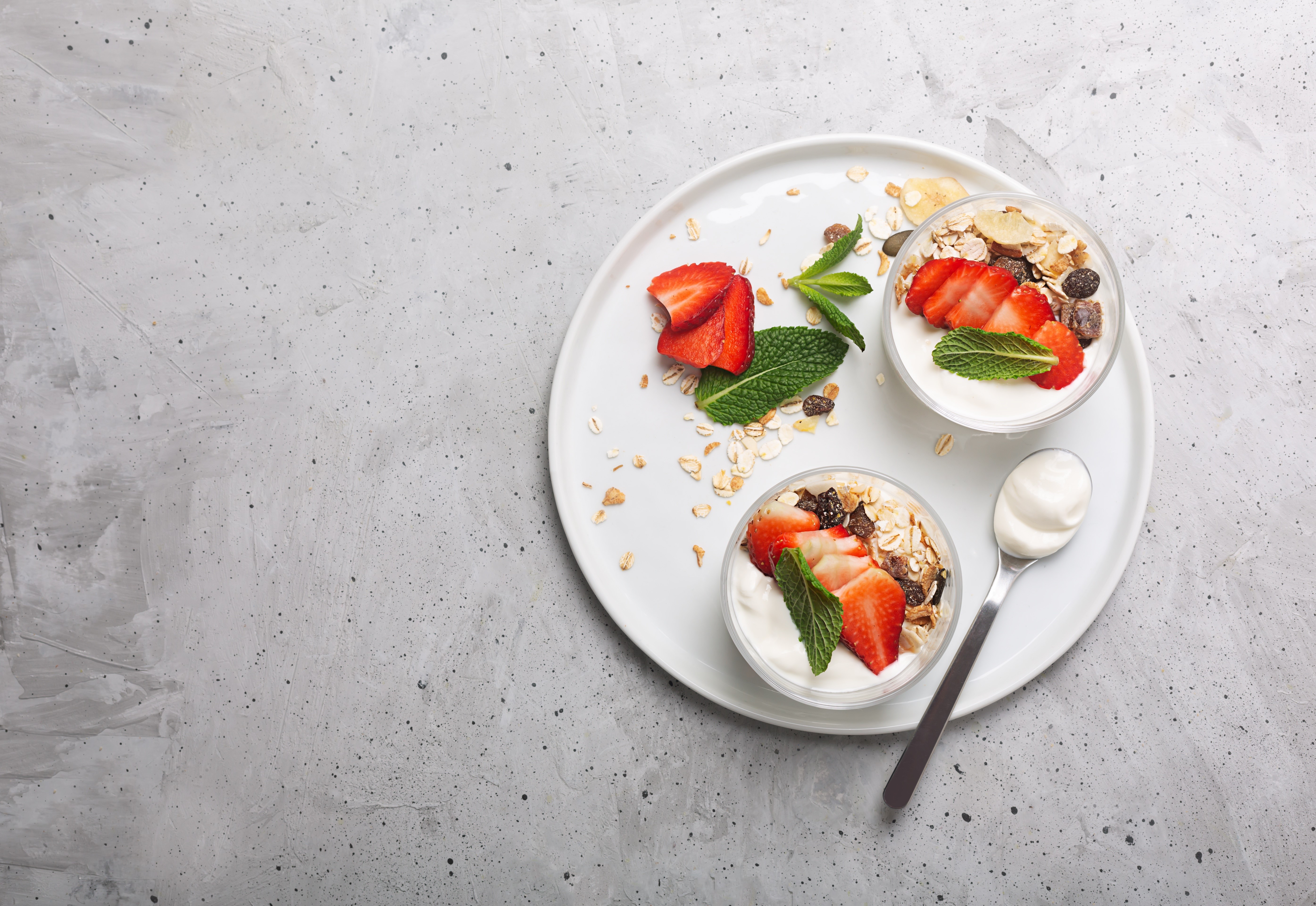 Yogurt with strawberries and muesli on a plate HD Wallpaper