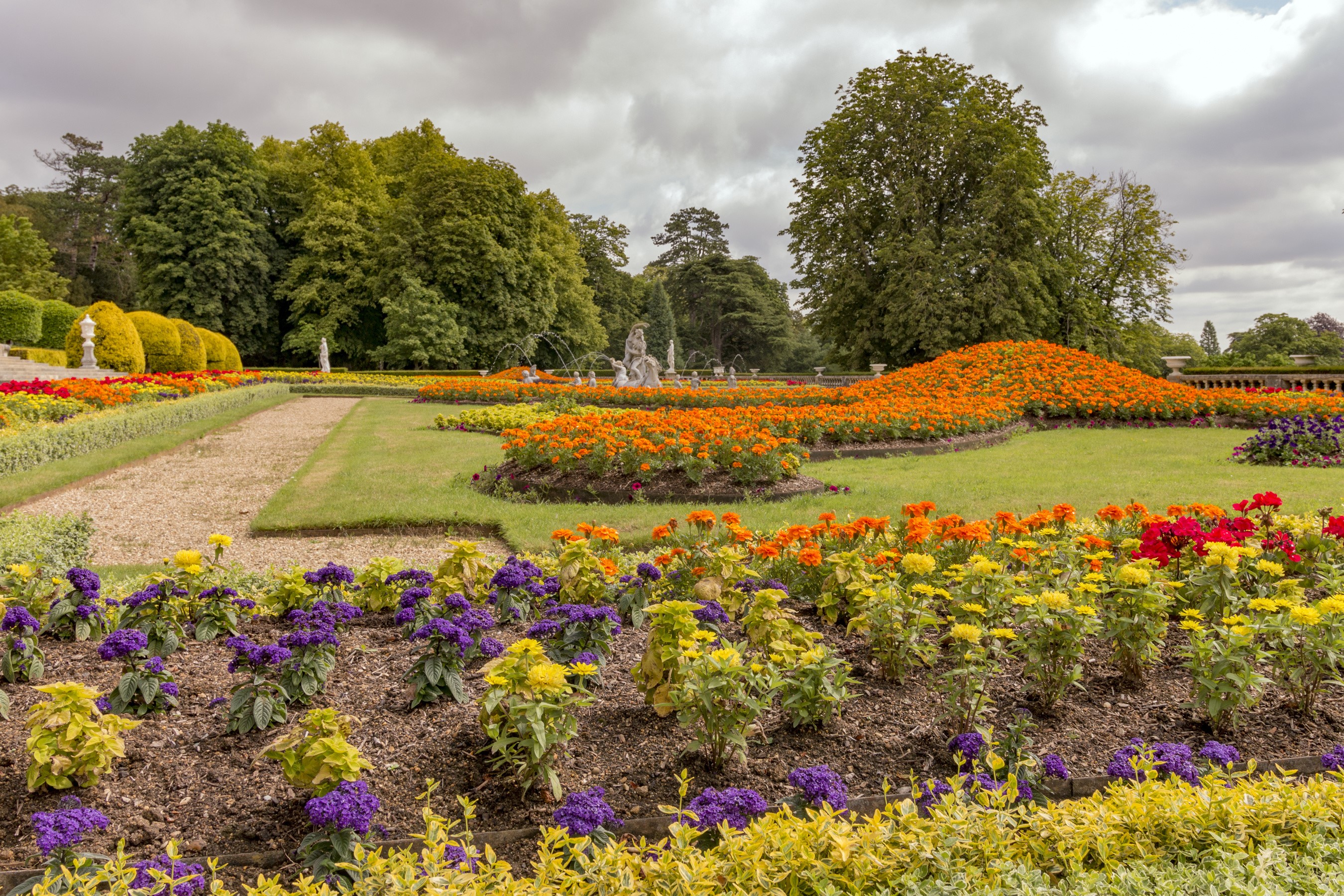 Waddesdon Manor gardens with flower beds and trees HD Wallpaper