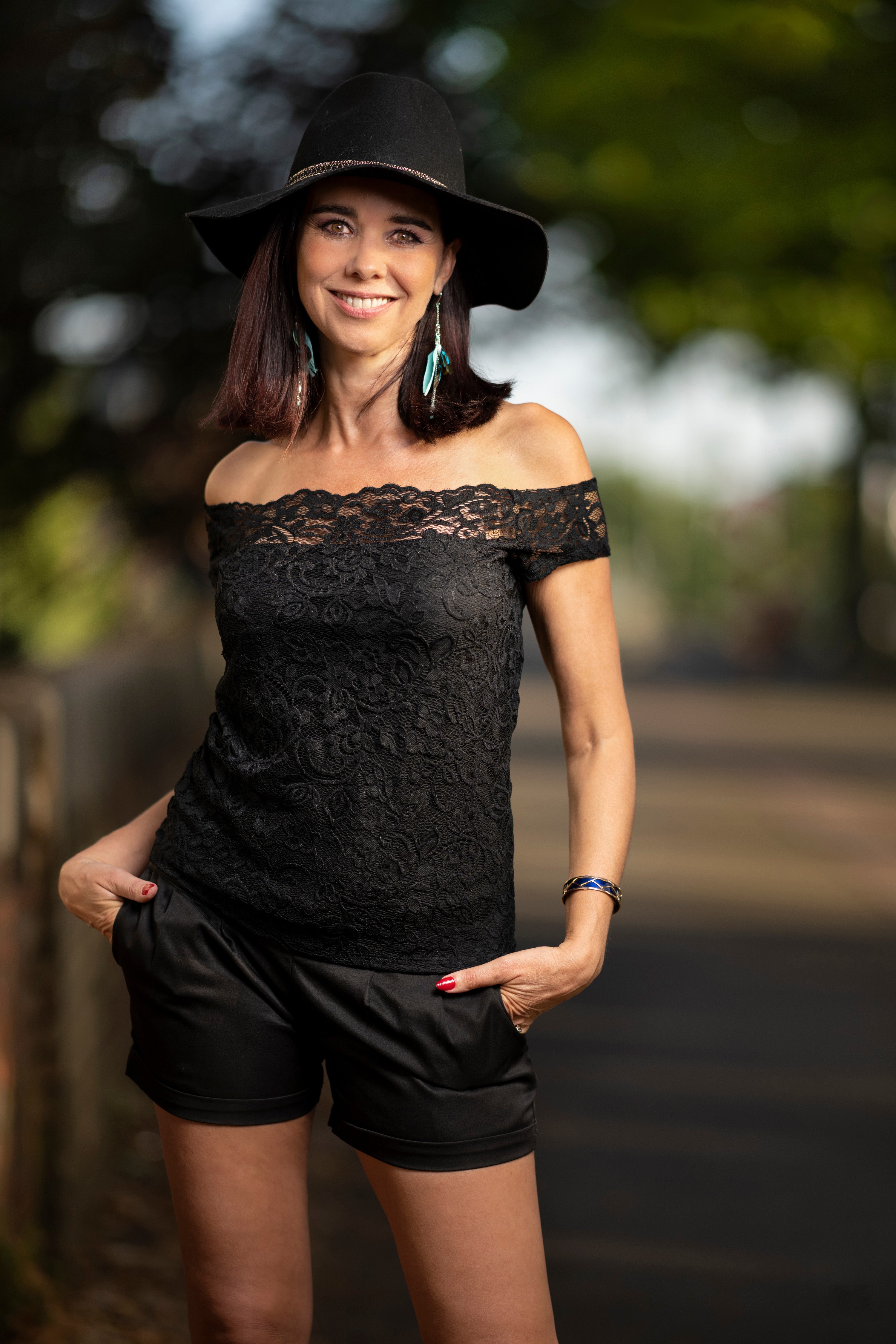 Christel wearing a black hat and off-the-shoulder top HD Phone Wallpaper