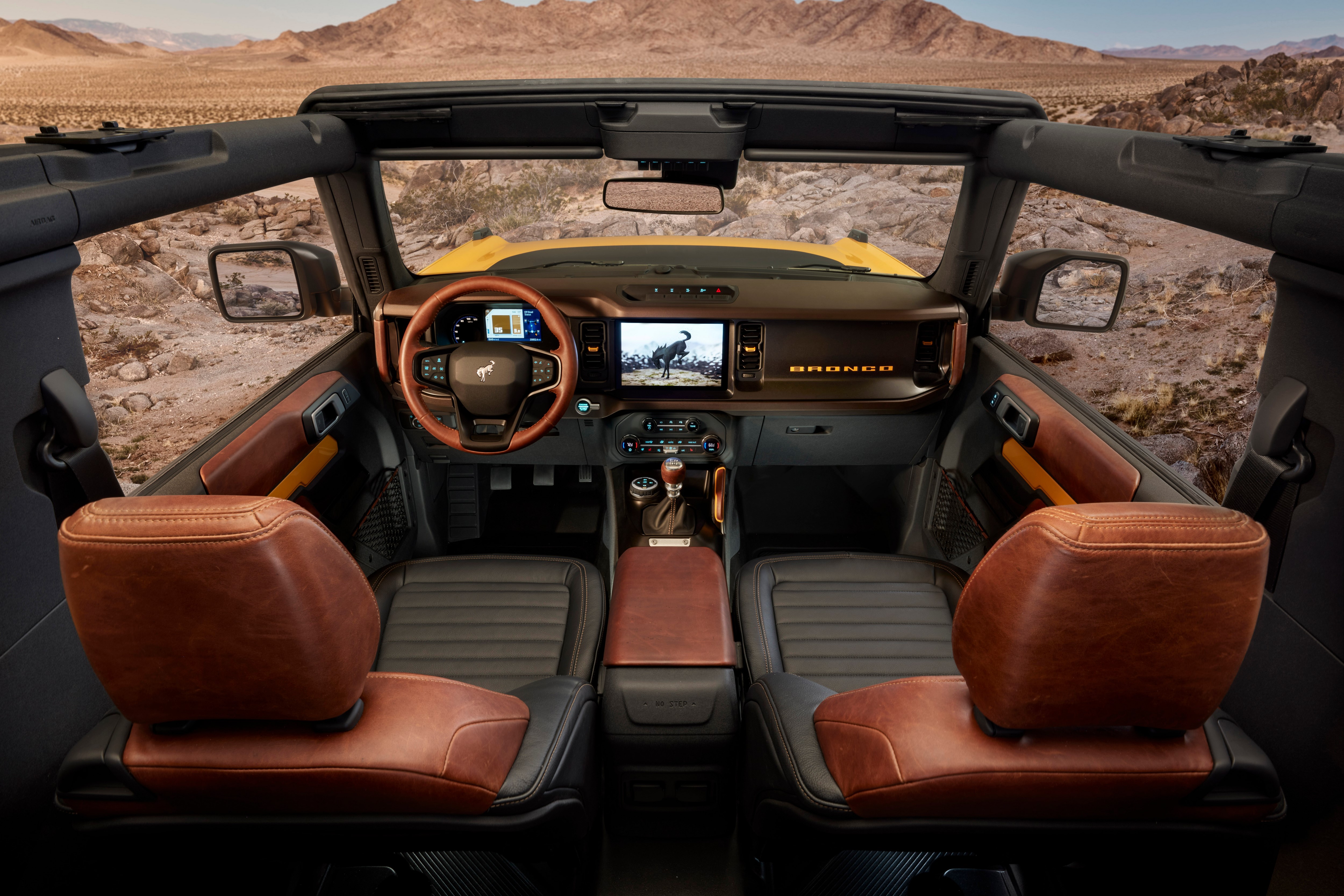 Interior of a Ford Bronco SUV in a desert landscape HD Wallpaper