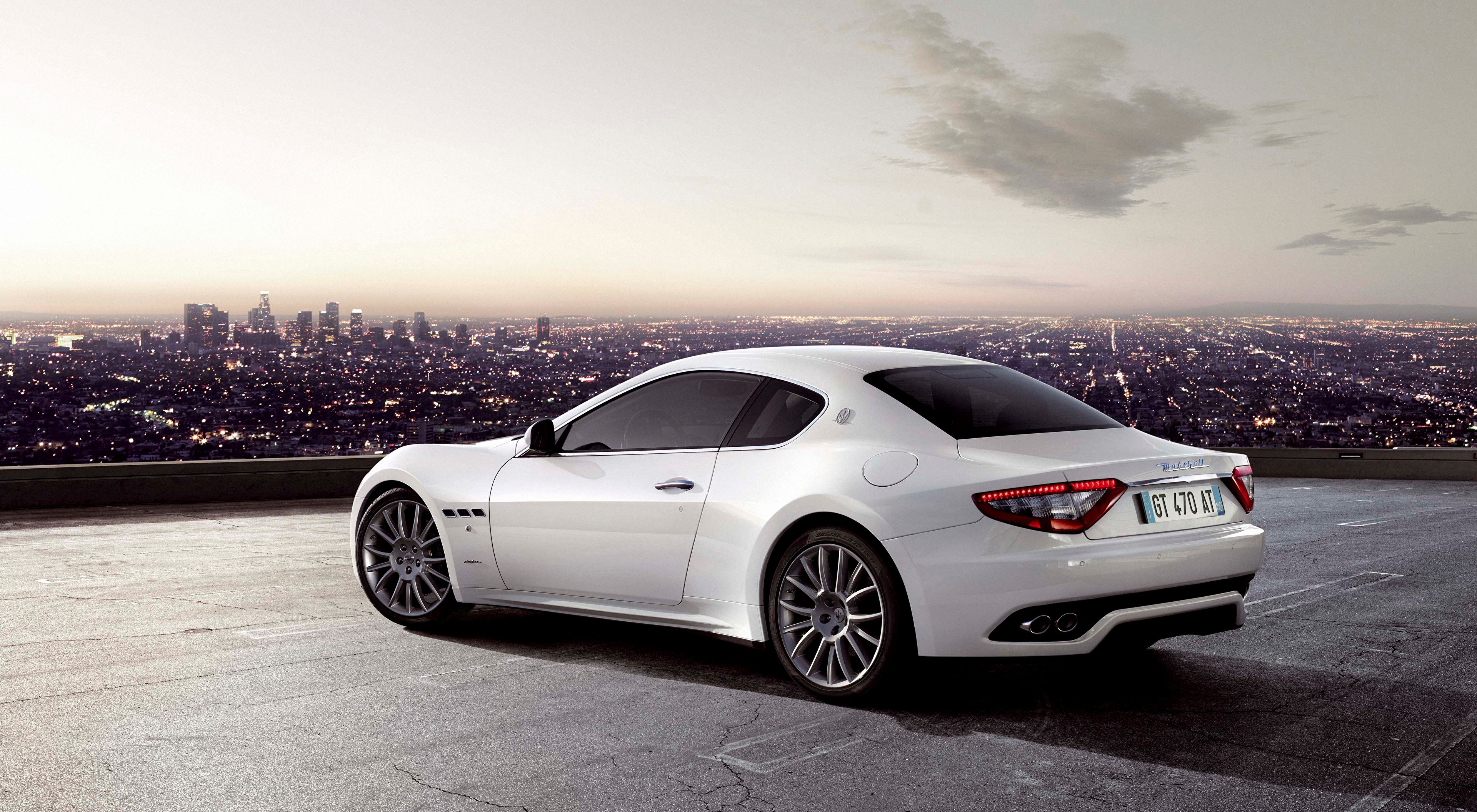 White Maserati Coupe on a Rooftop Overlooking Cityscape HD Wallpaper