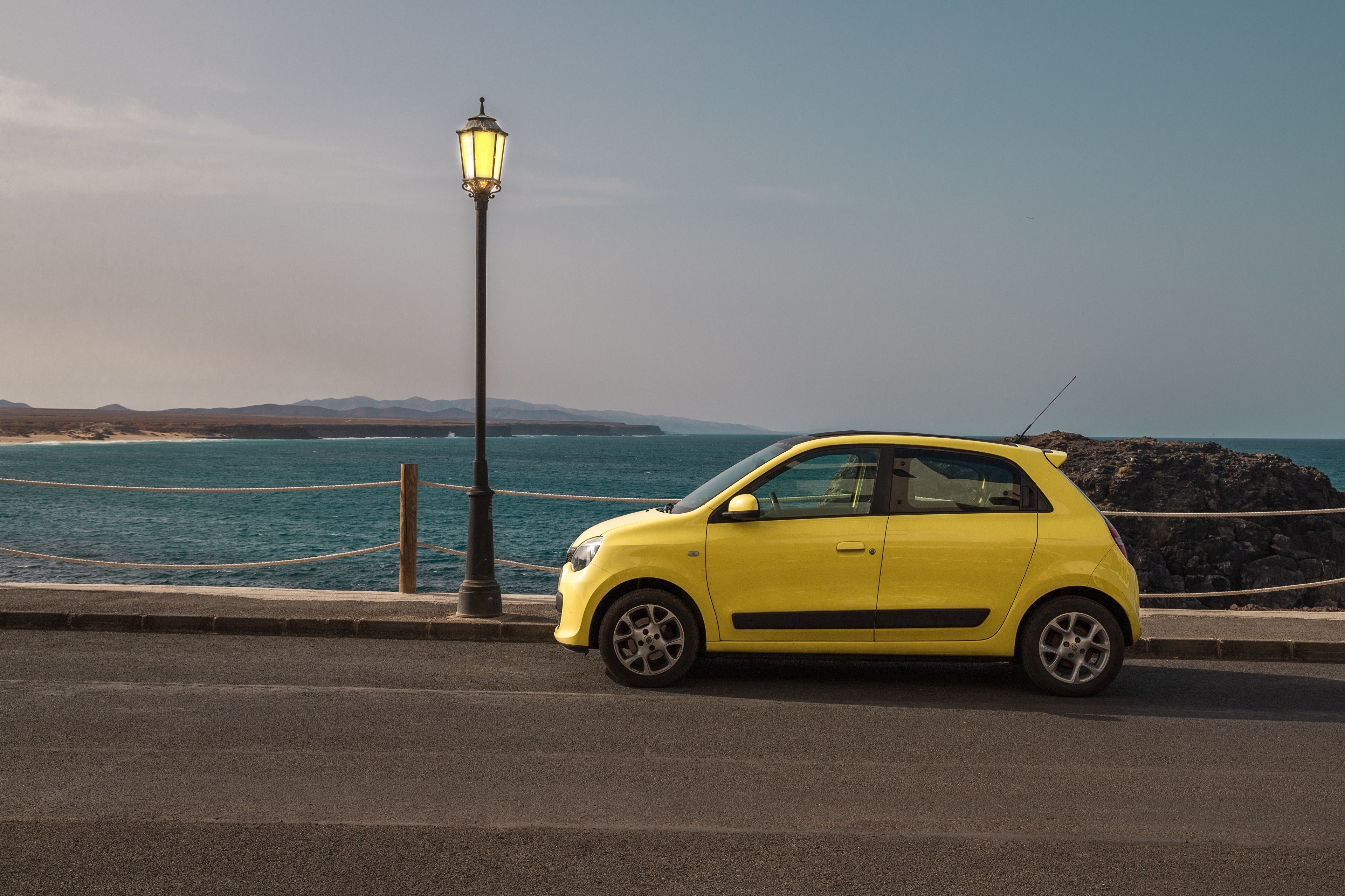Yellow Renault Twingo parked by the sea HD Wallpaper