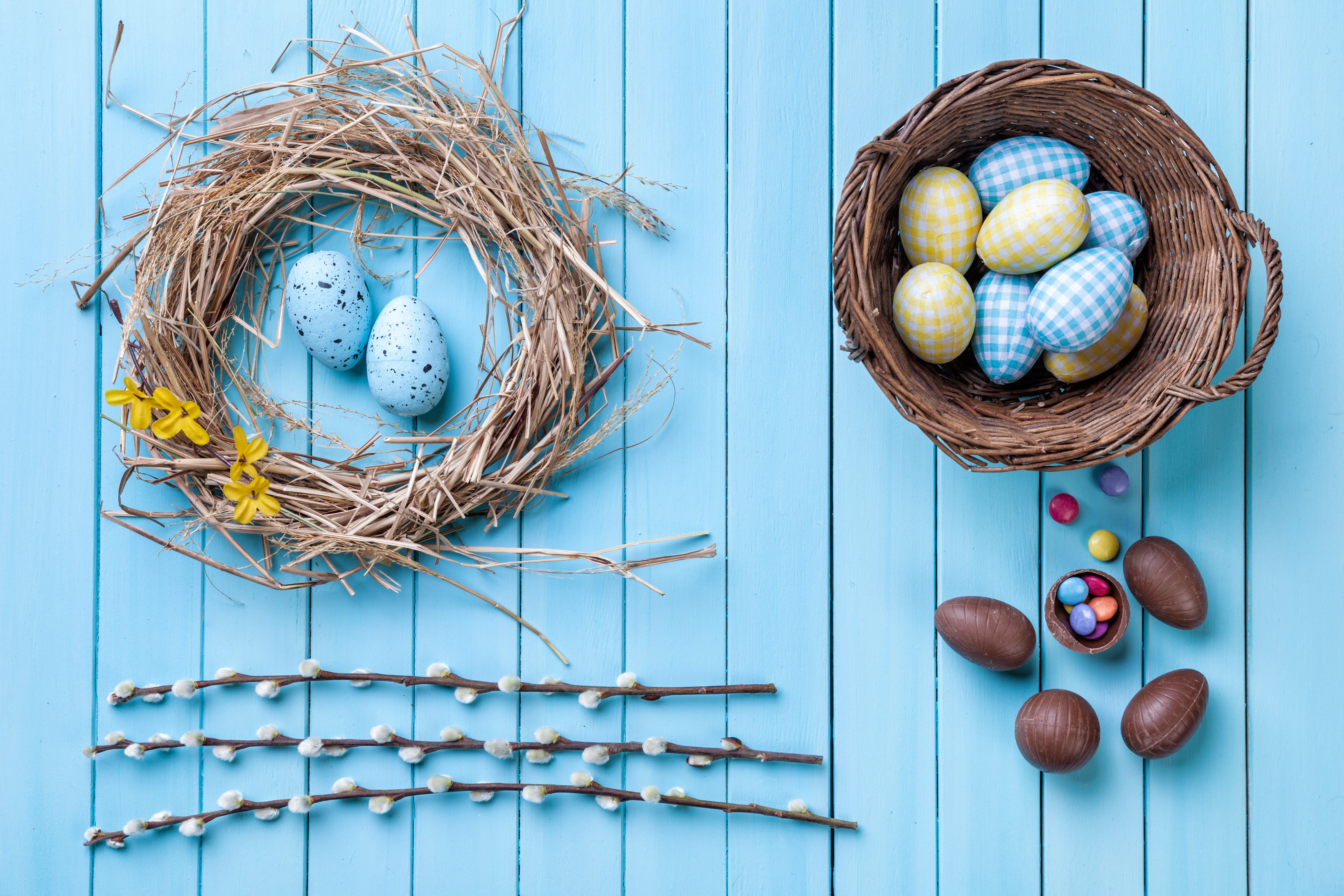 Easter Eggs in Nest and Wicker Basket on Wood Planks HD Wallpaper