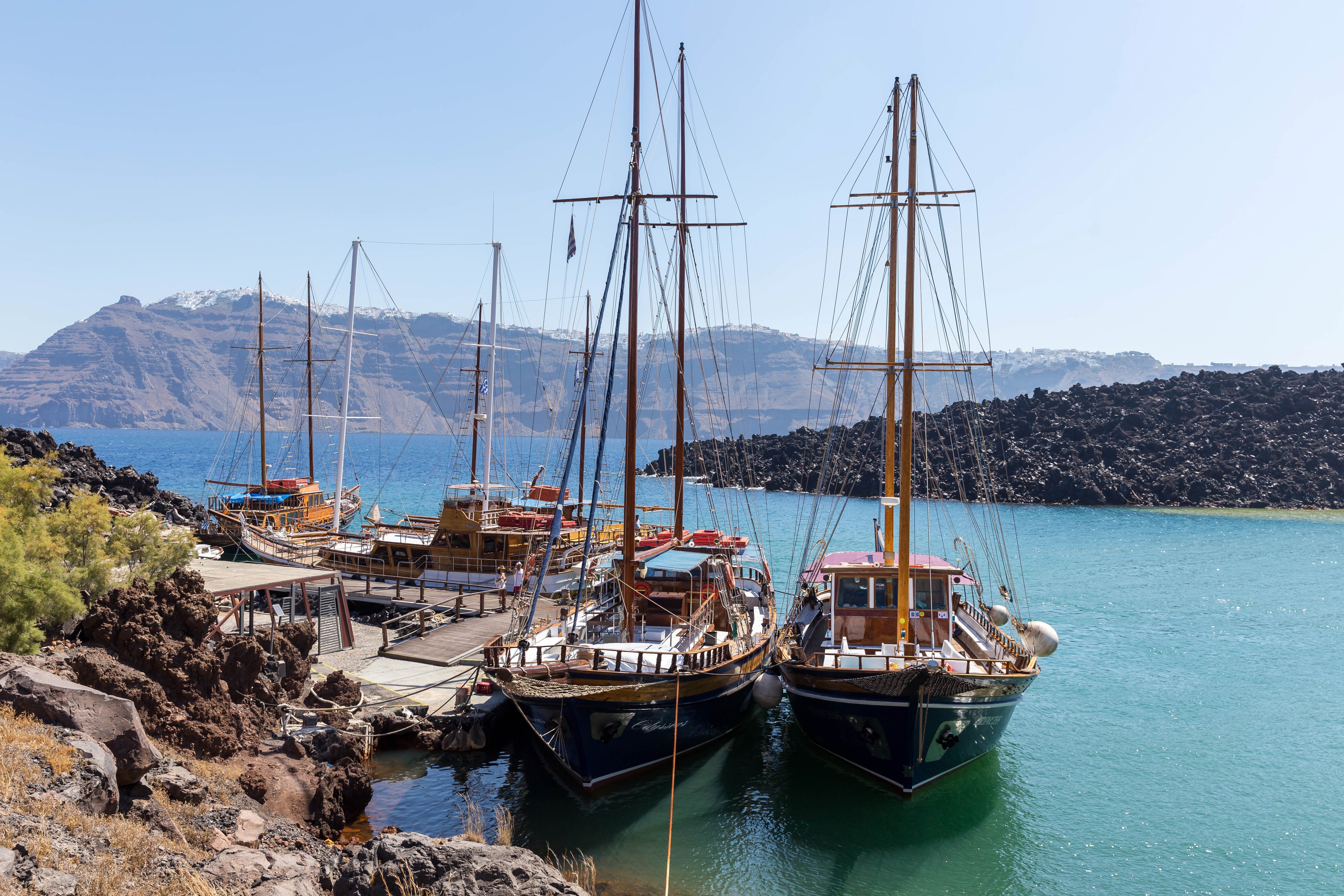 Sailing ships docked in a bay in Santorini, Greece HD Wallpaper