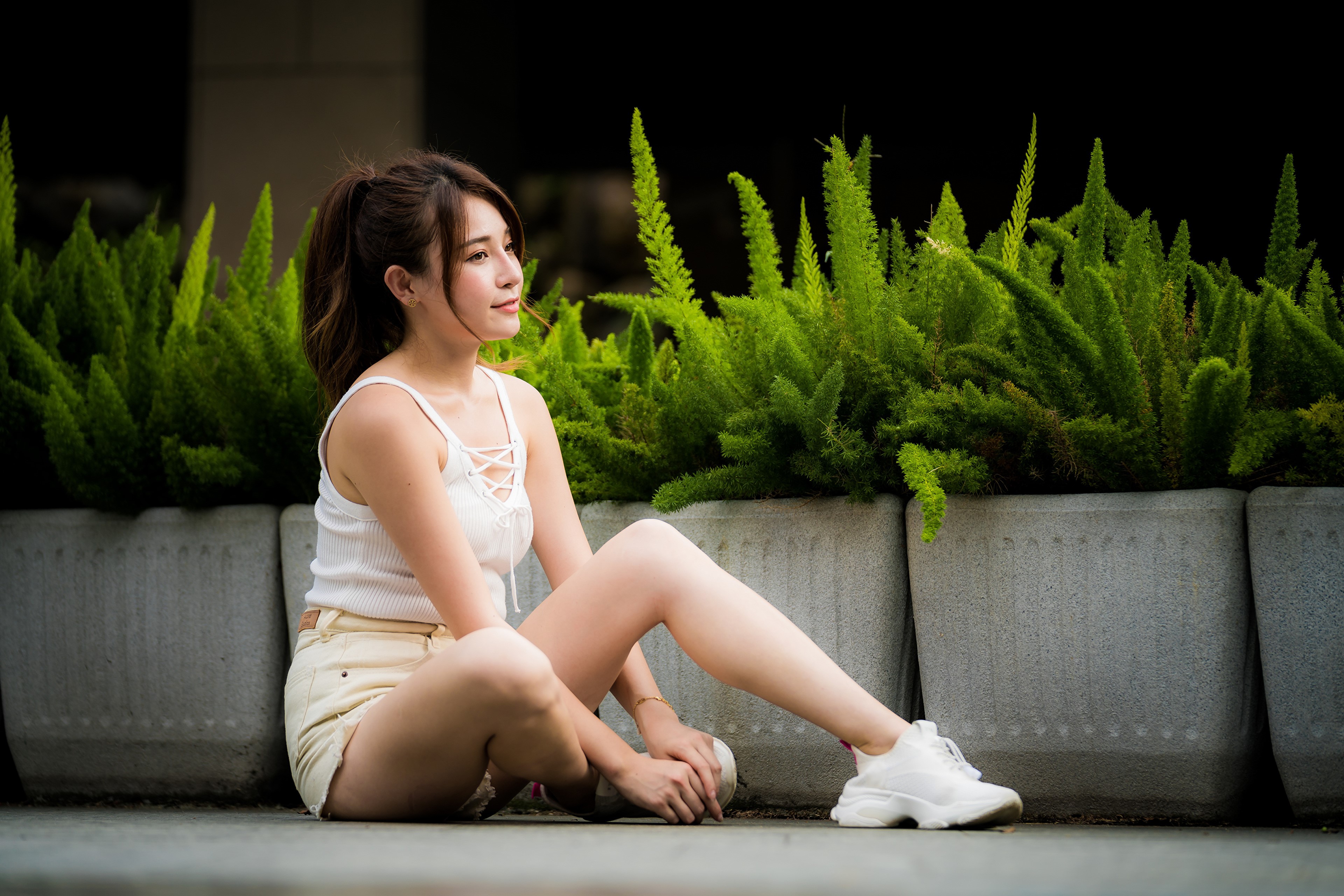 Asian woman sitting in shorts and singlet HD Wallpaper