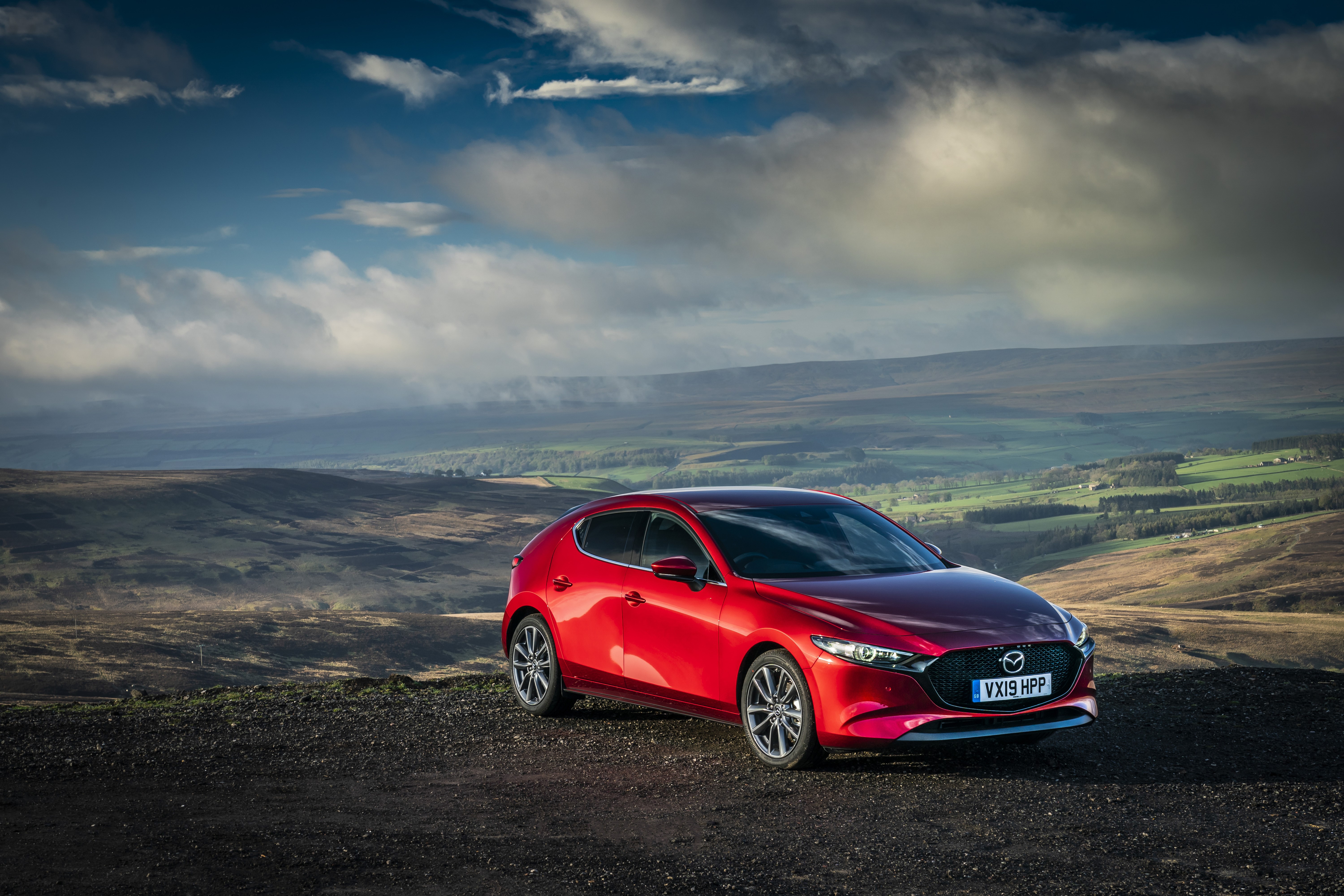 Red 2019 Mazda3 Skyactiv-G Hatchback in a landscape HD Wallpaper