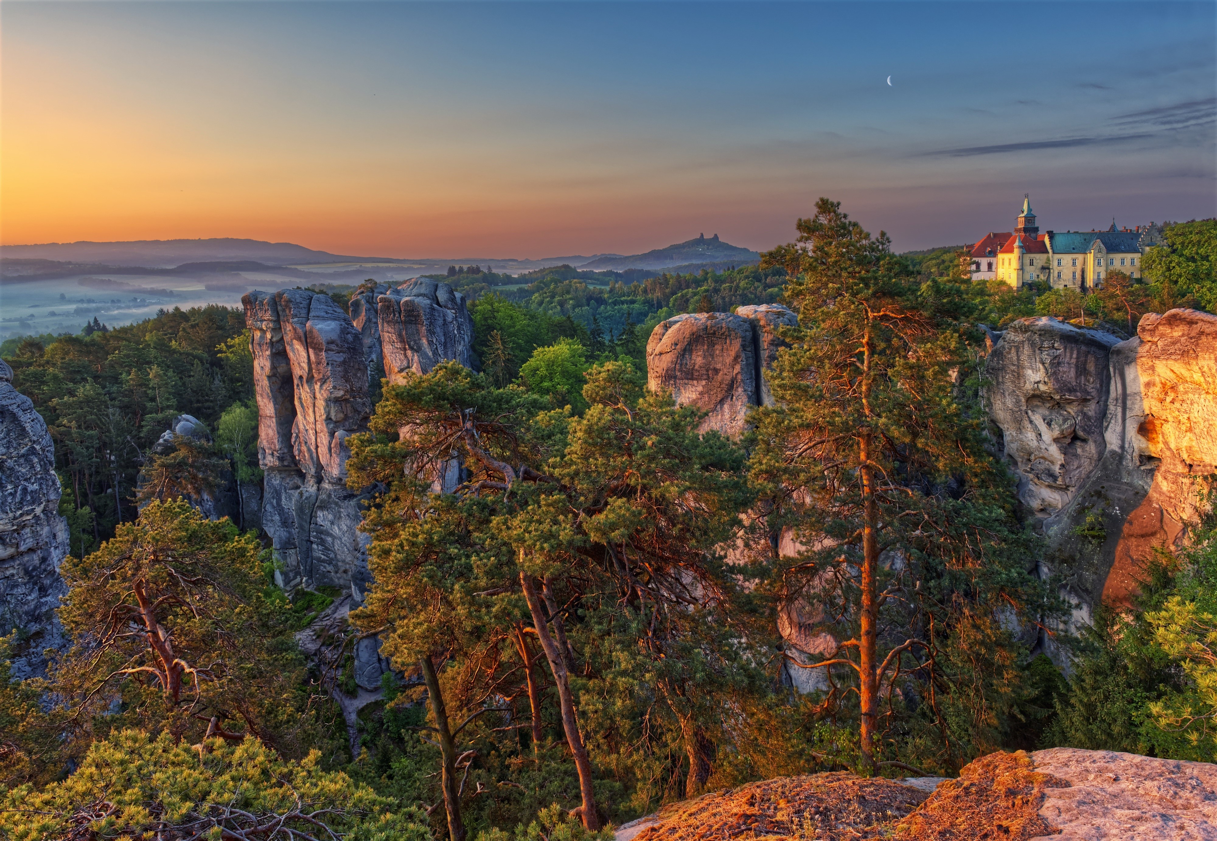Sunrise over rock formations and castle in Czech Republic HD Wallpaper