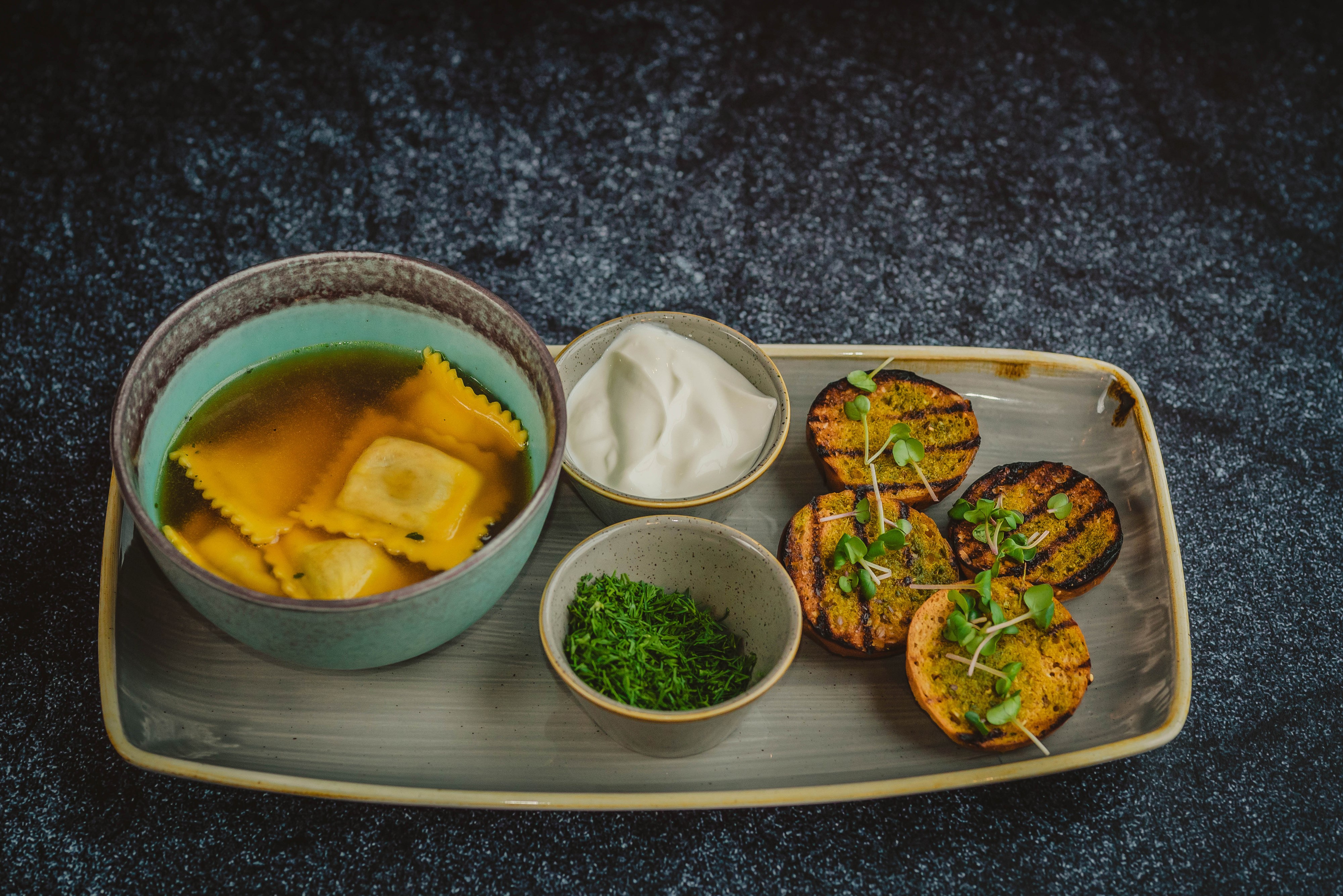 Ravioli soup with sour cream, dill, and grilled bread HD Wallpaper