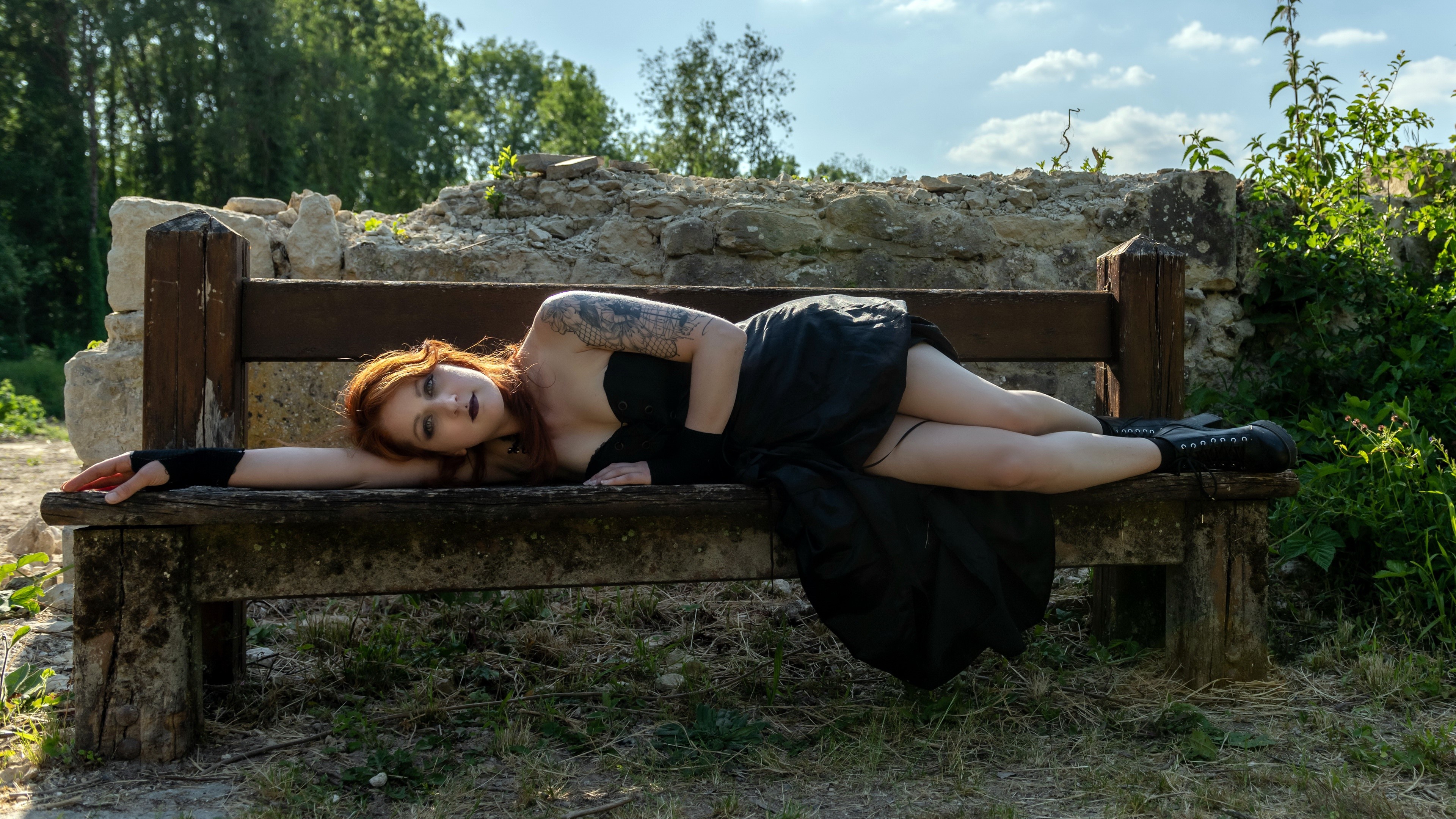 Woman with tattoos lying on a bench HD Wallpaper