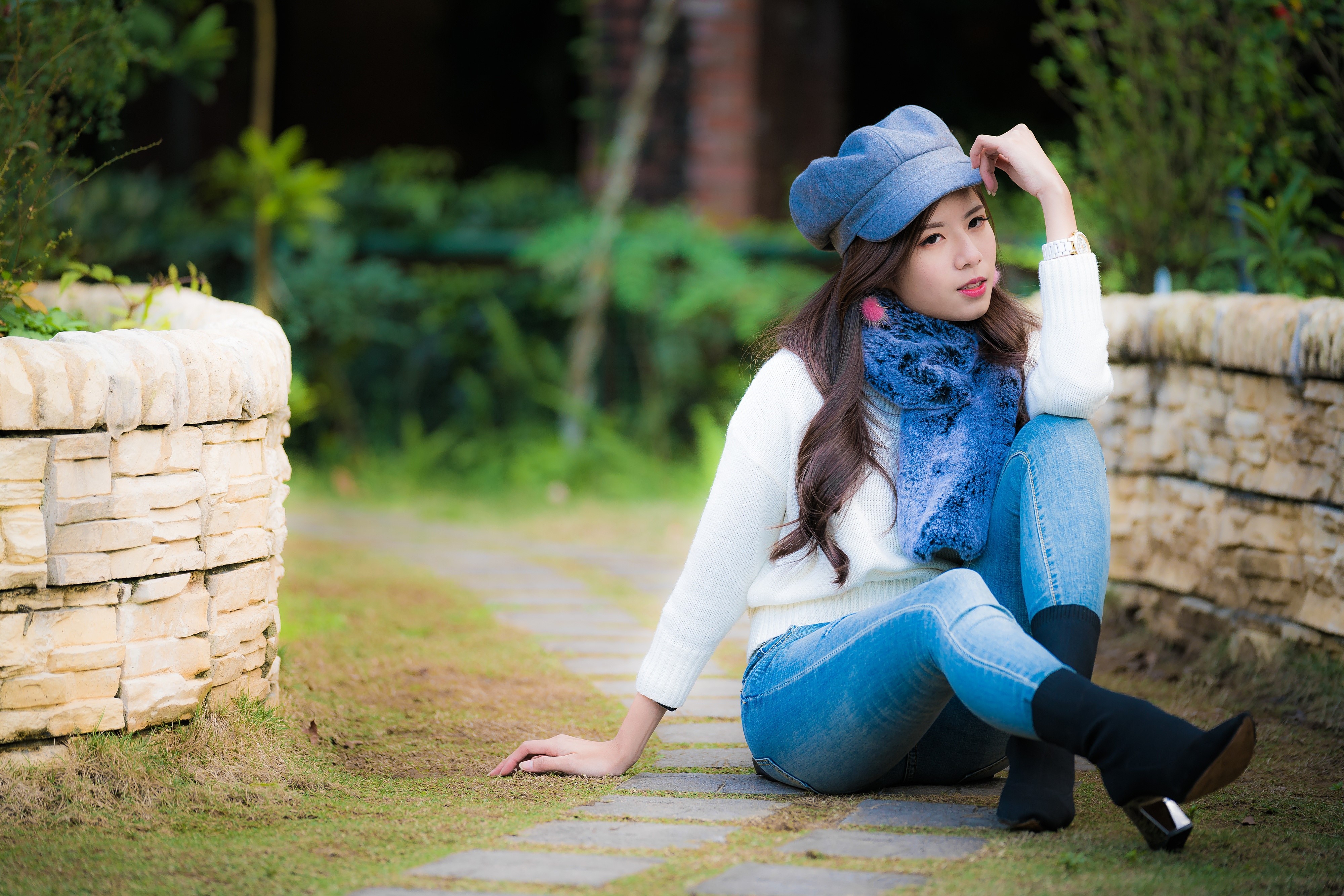 4K Asian Woman Sitting Outdoors in Jeans and Sweater HD Wallpaper
