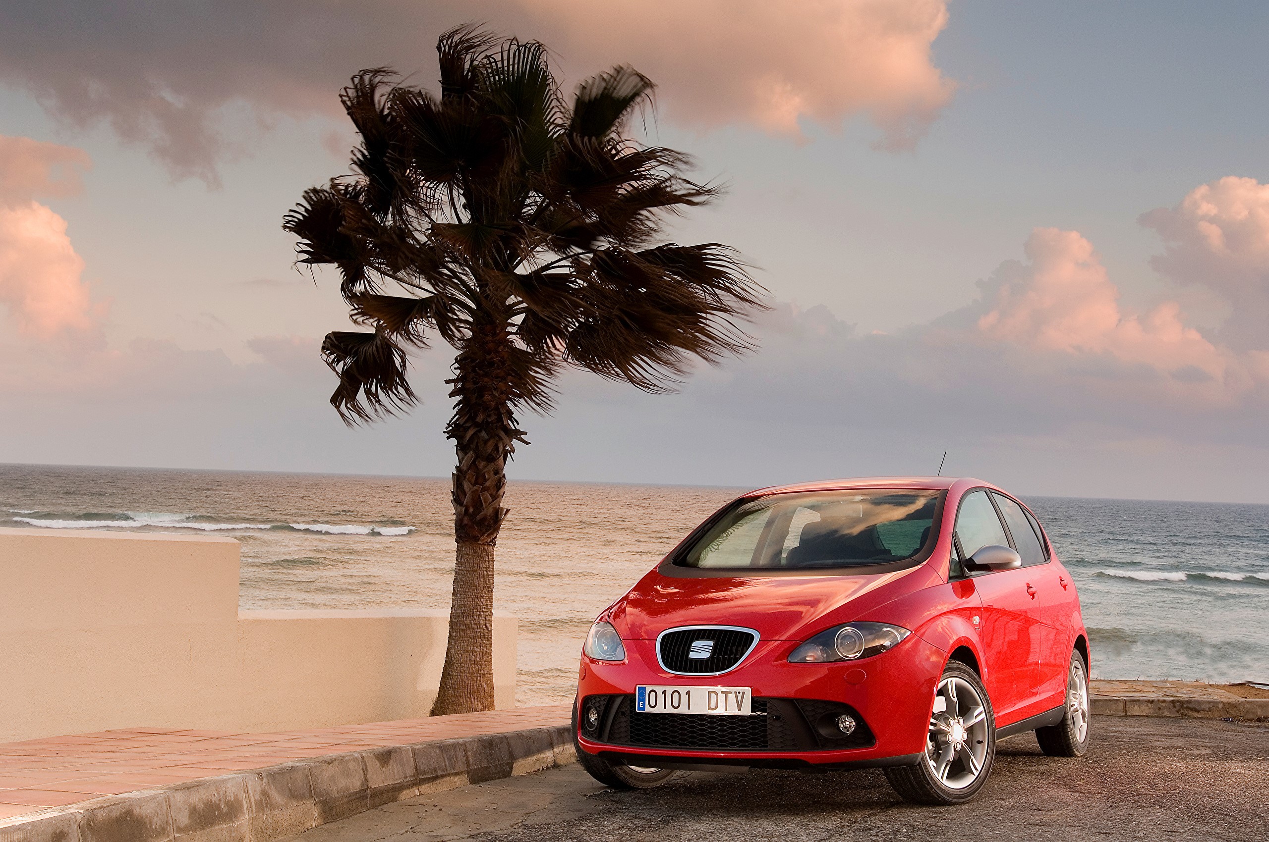 Red Seat car parked by the ocean with palm tree HD Wallpaper