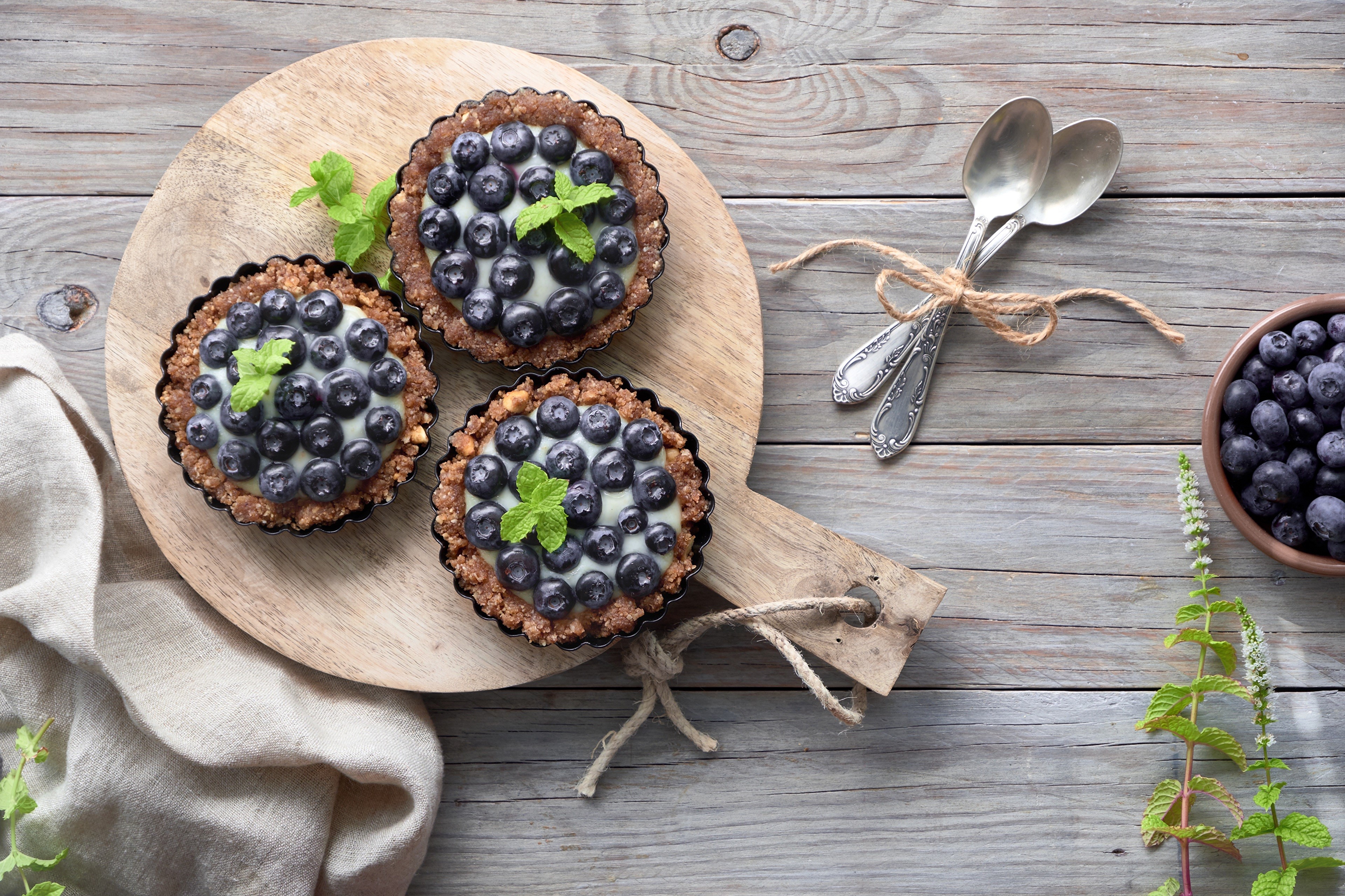 Blueberry tarts with mint on a wooden board HD Wallpaper