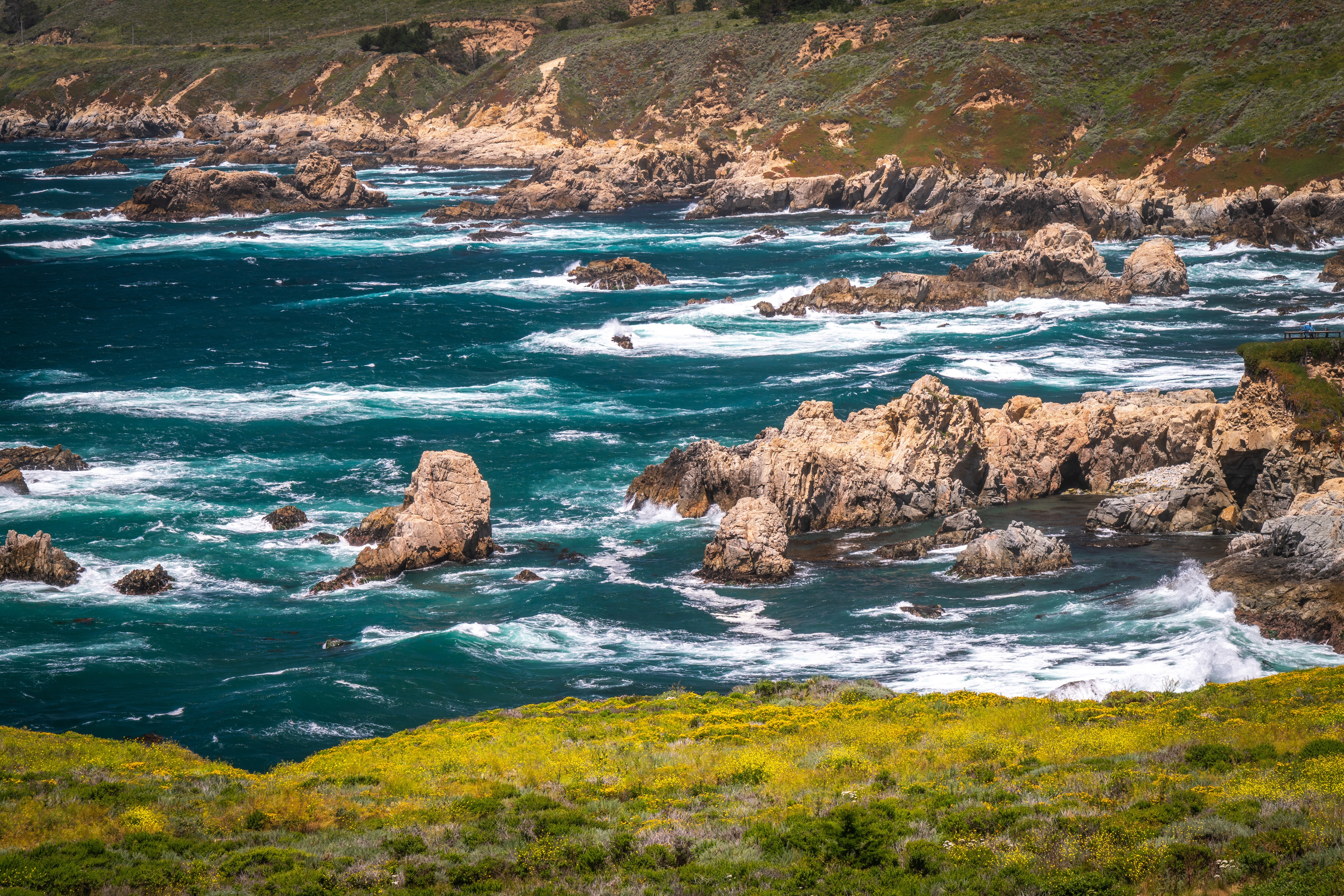 California Coastline with Rocky Outcrops and Waves HD Wallpaper