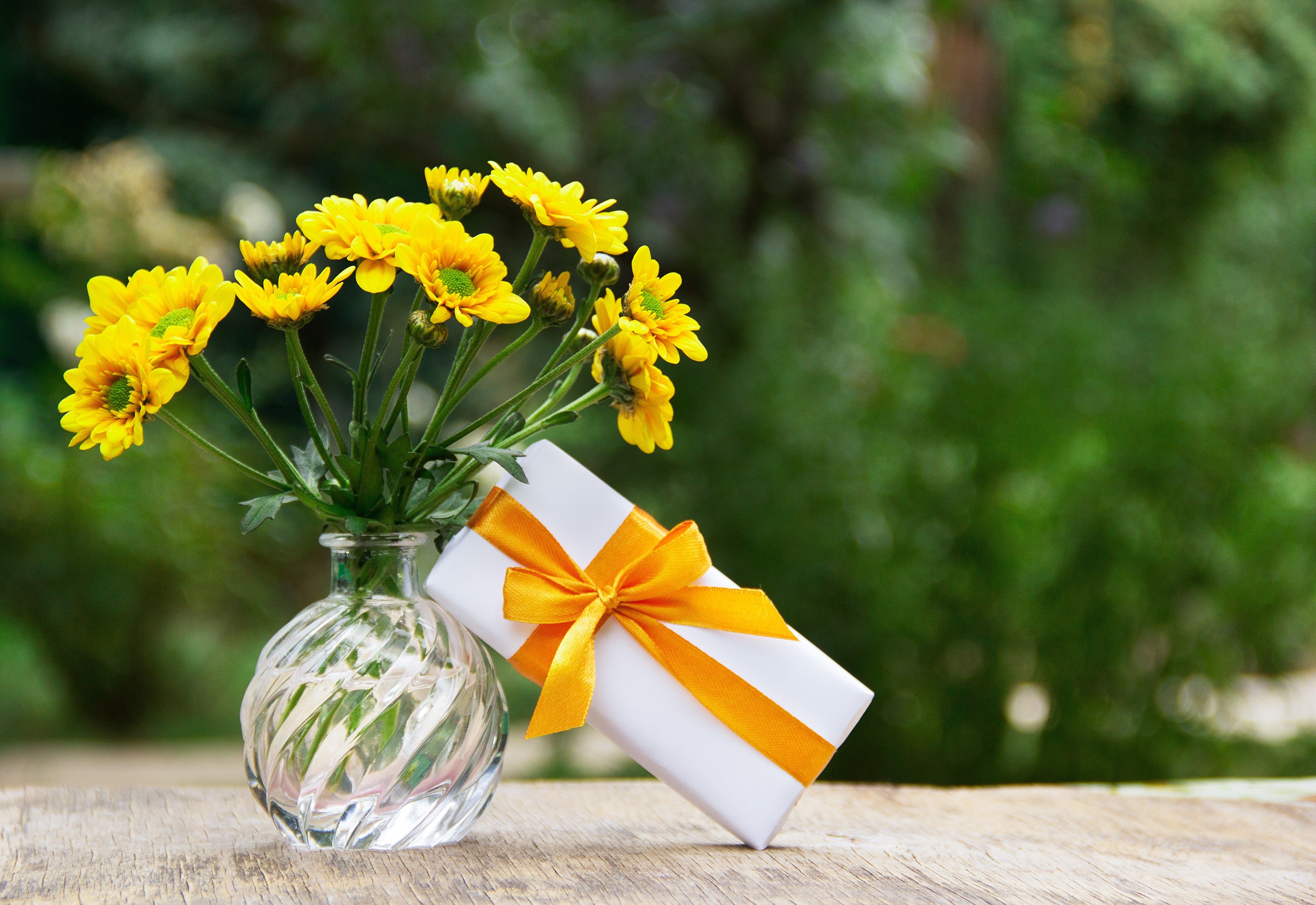 Yellow flowers in a vase with a gift box HD Wallpaper