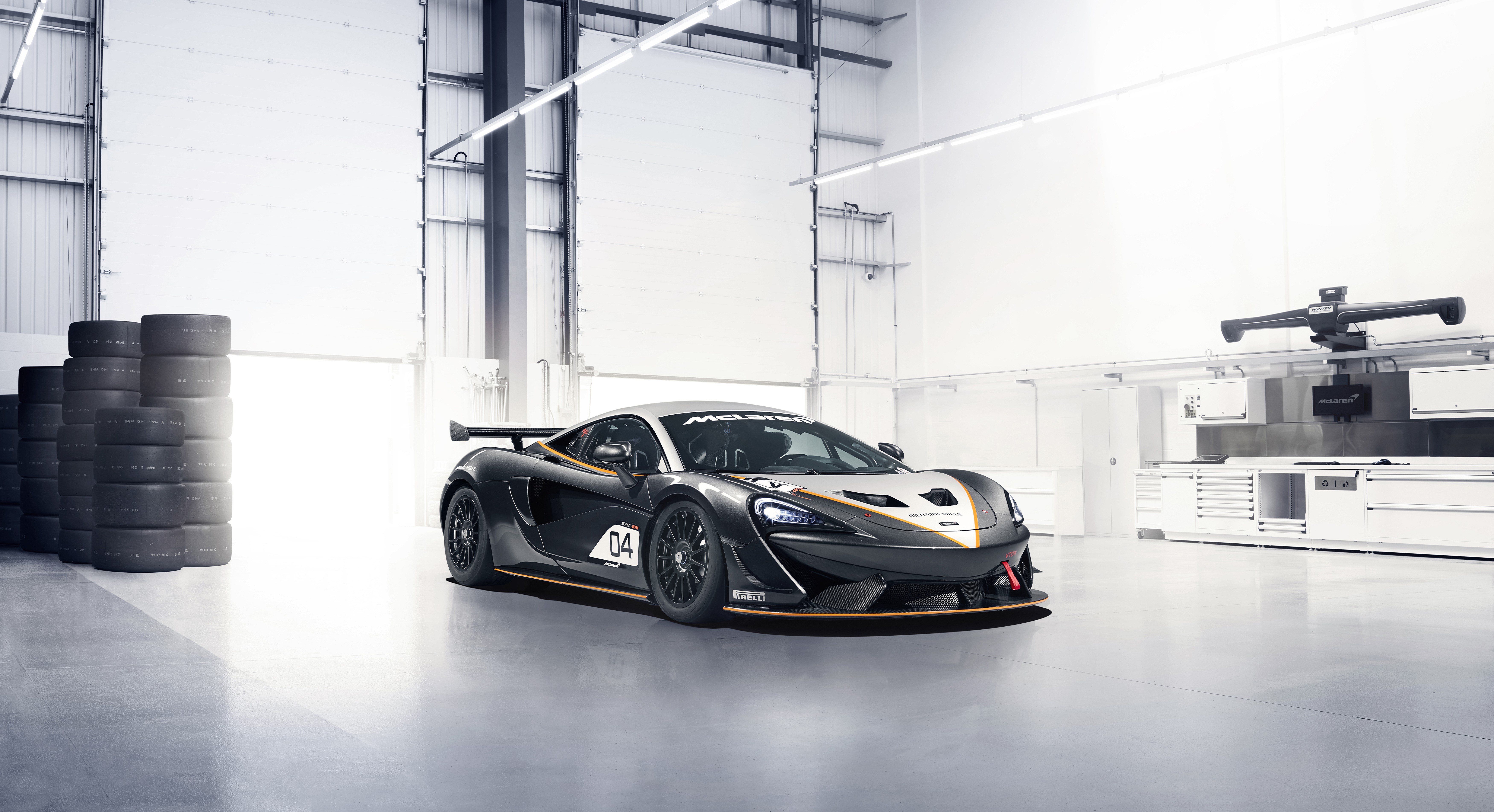 McLaren 570S GT4 race car in a garage HD Wallpaper