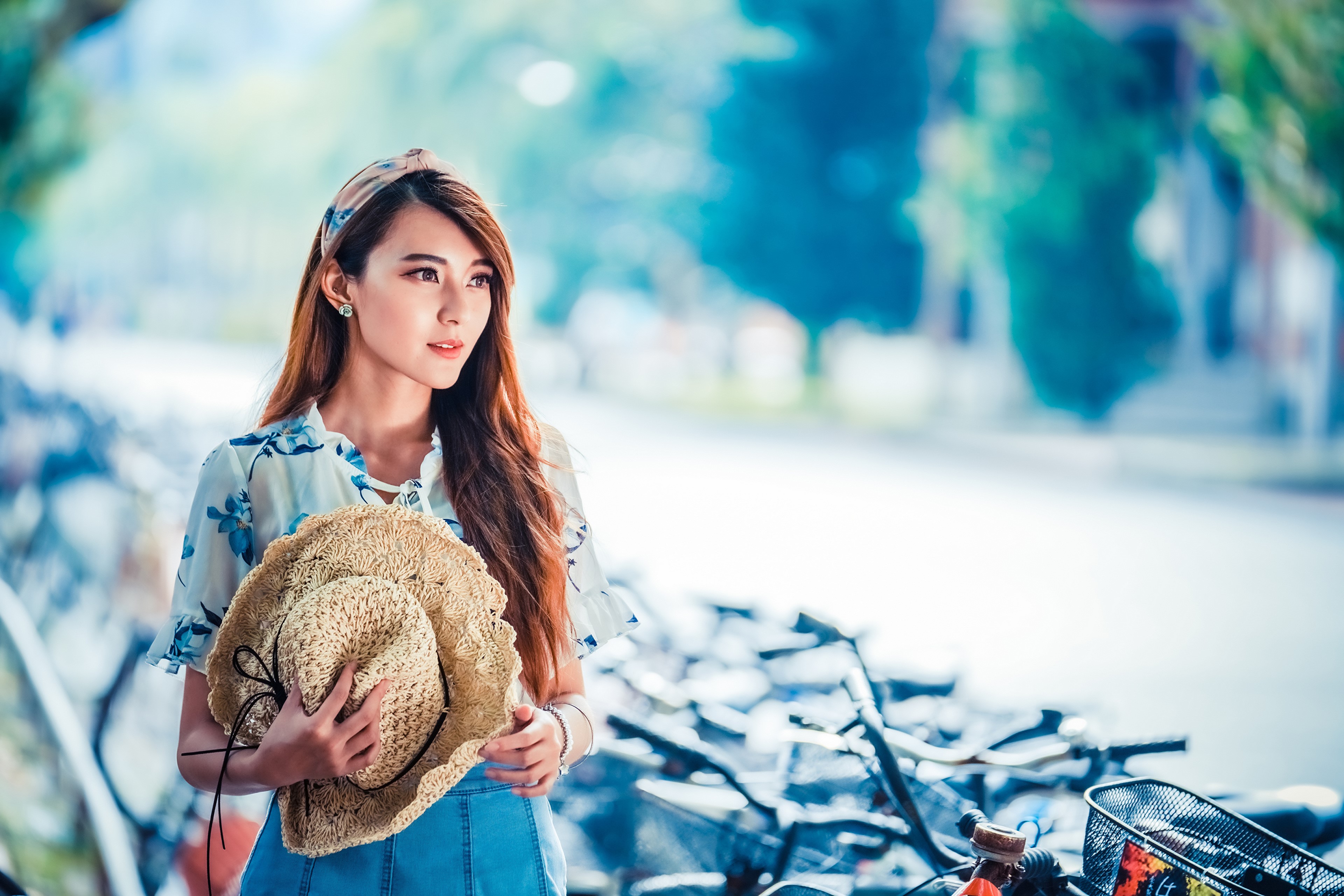 Asian woman with brown hair holding a hat HD Wallpaper