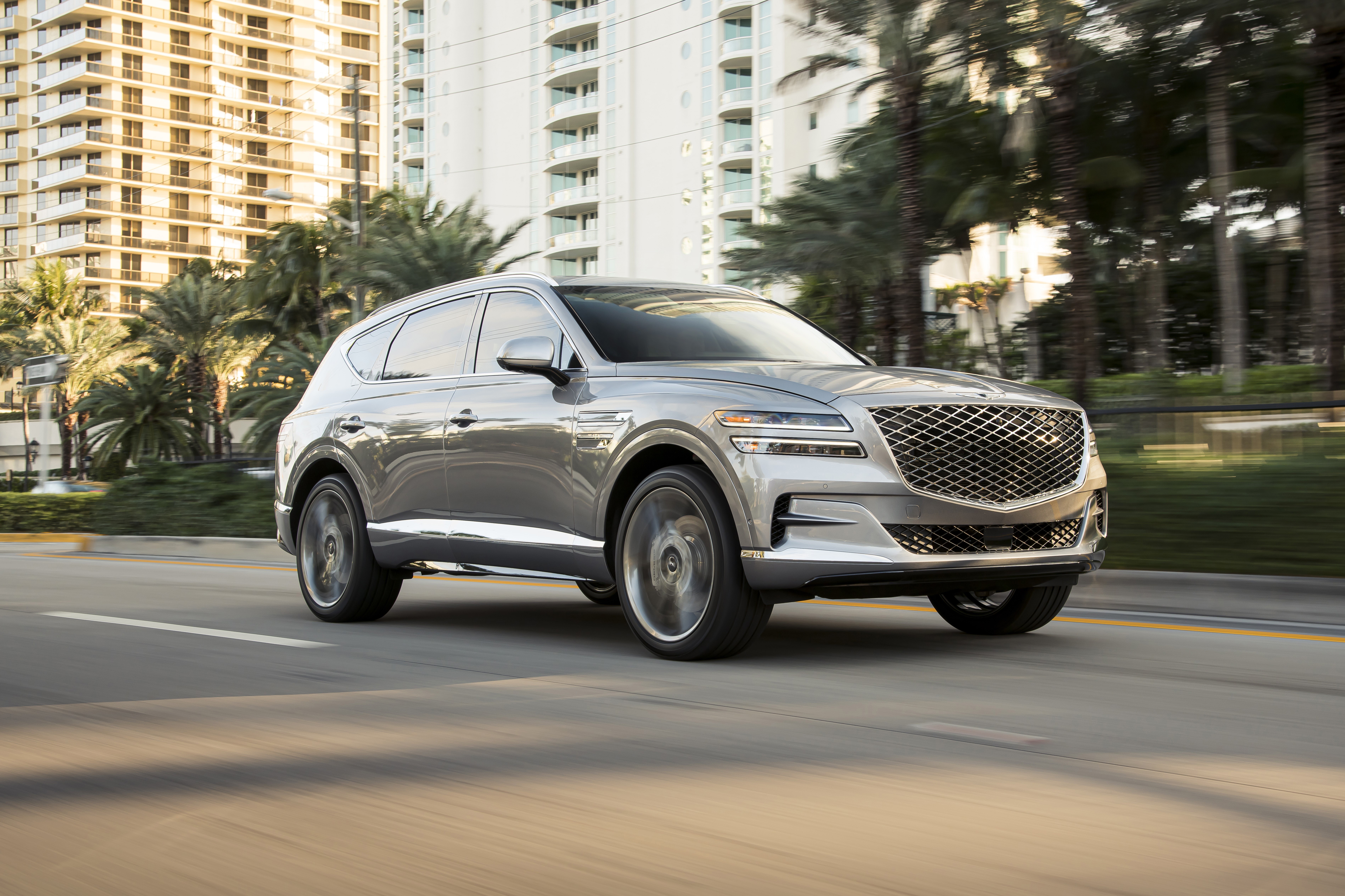 Genesis GV80 driving on a road HD Wallpaper