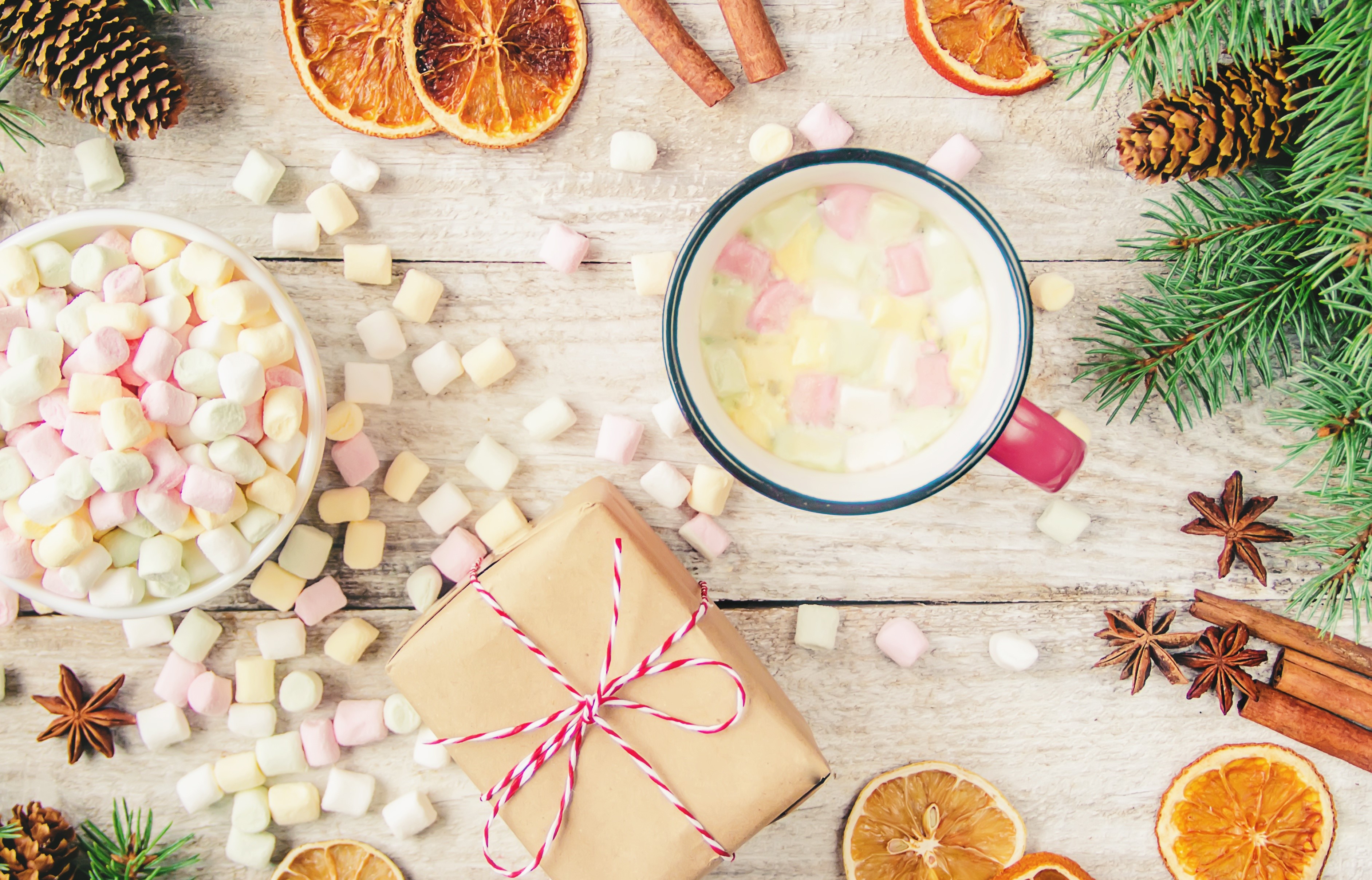 Christmas scene with marshmallows, gift, and hot drink HD Wallpaper