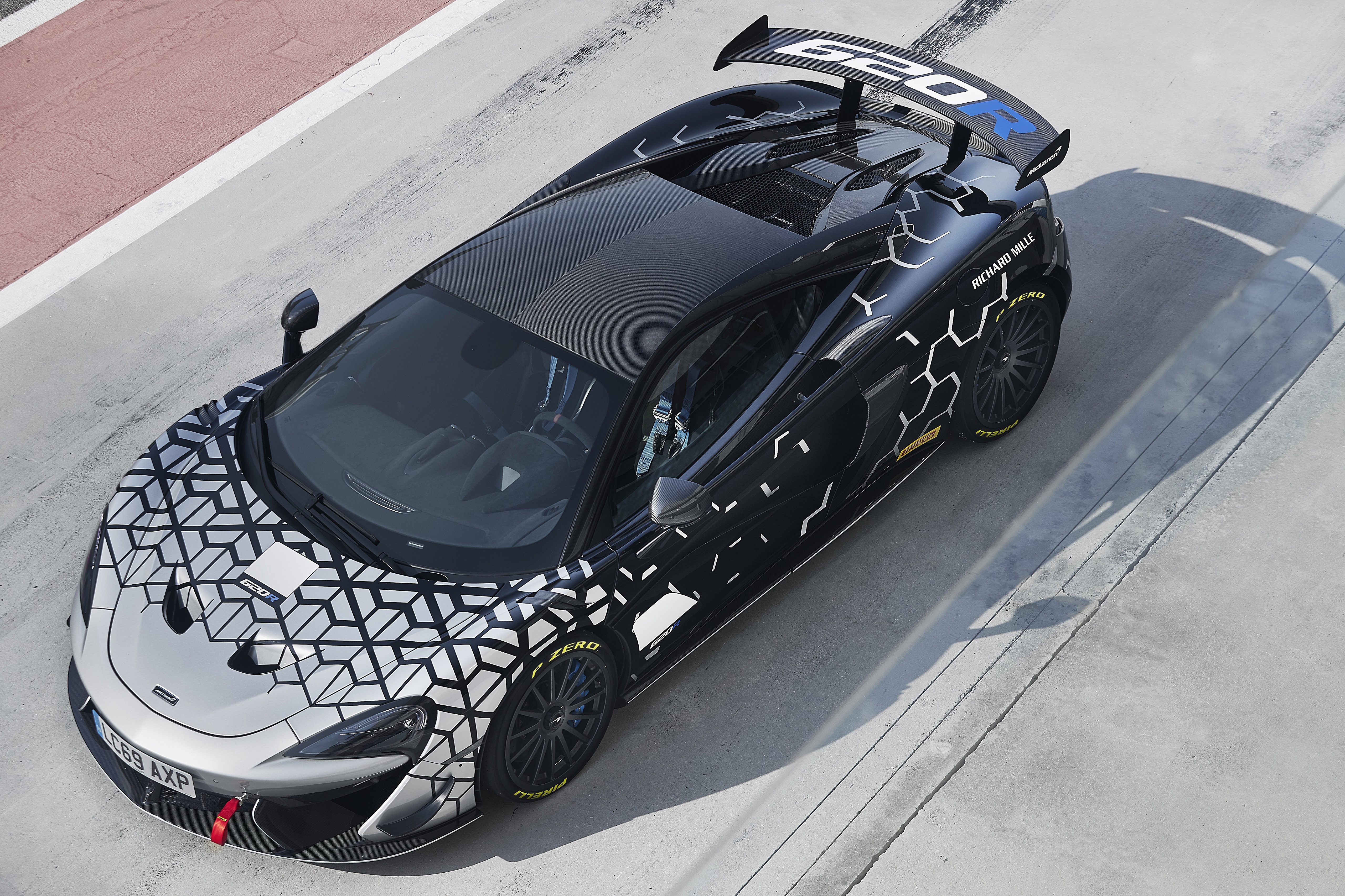 McLaren 620R race car with geometric camouflage HD Wallpaper