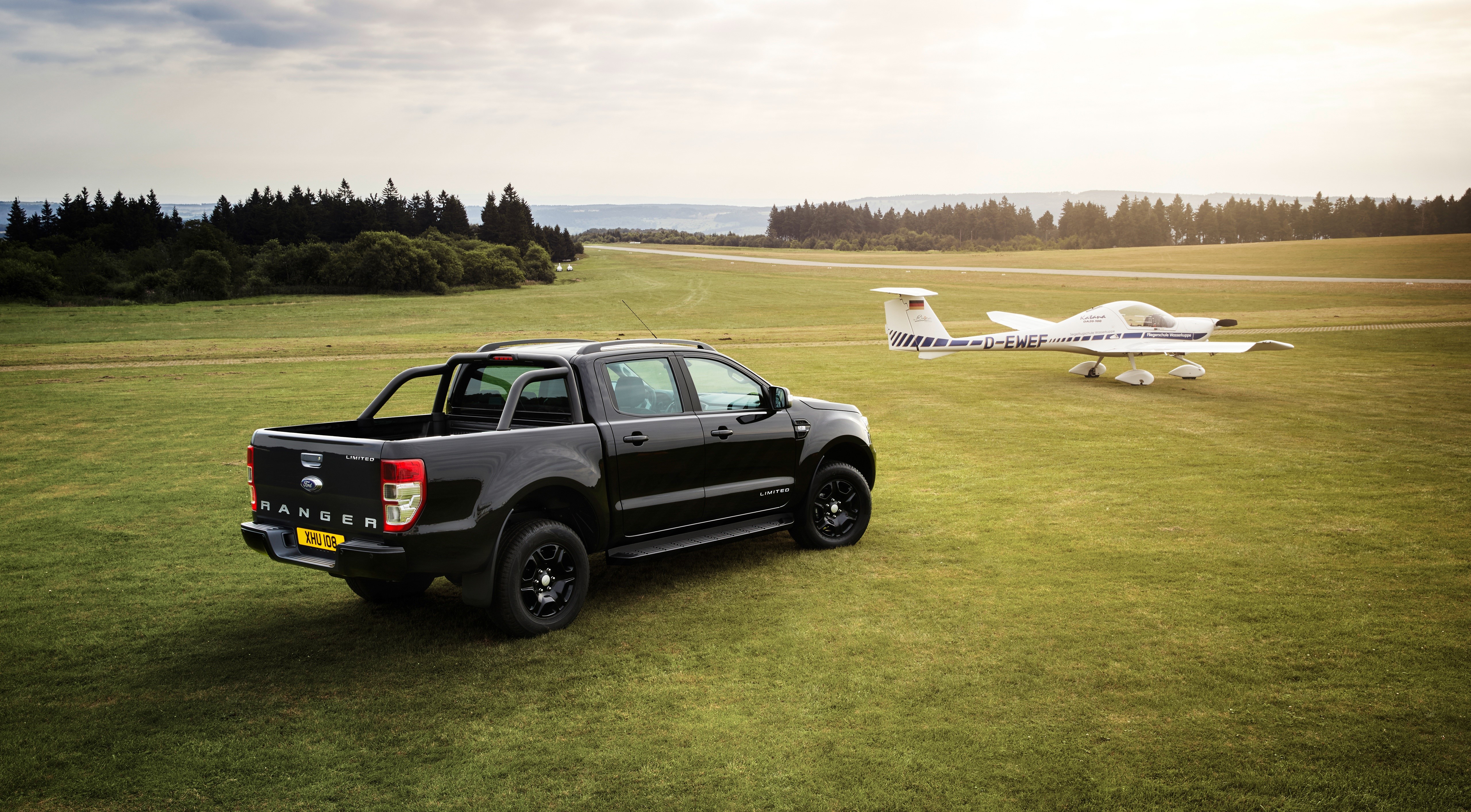 Black Ford Ranger pickup truck and airplane on grass field HD Wallpaper