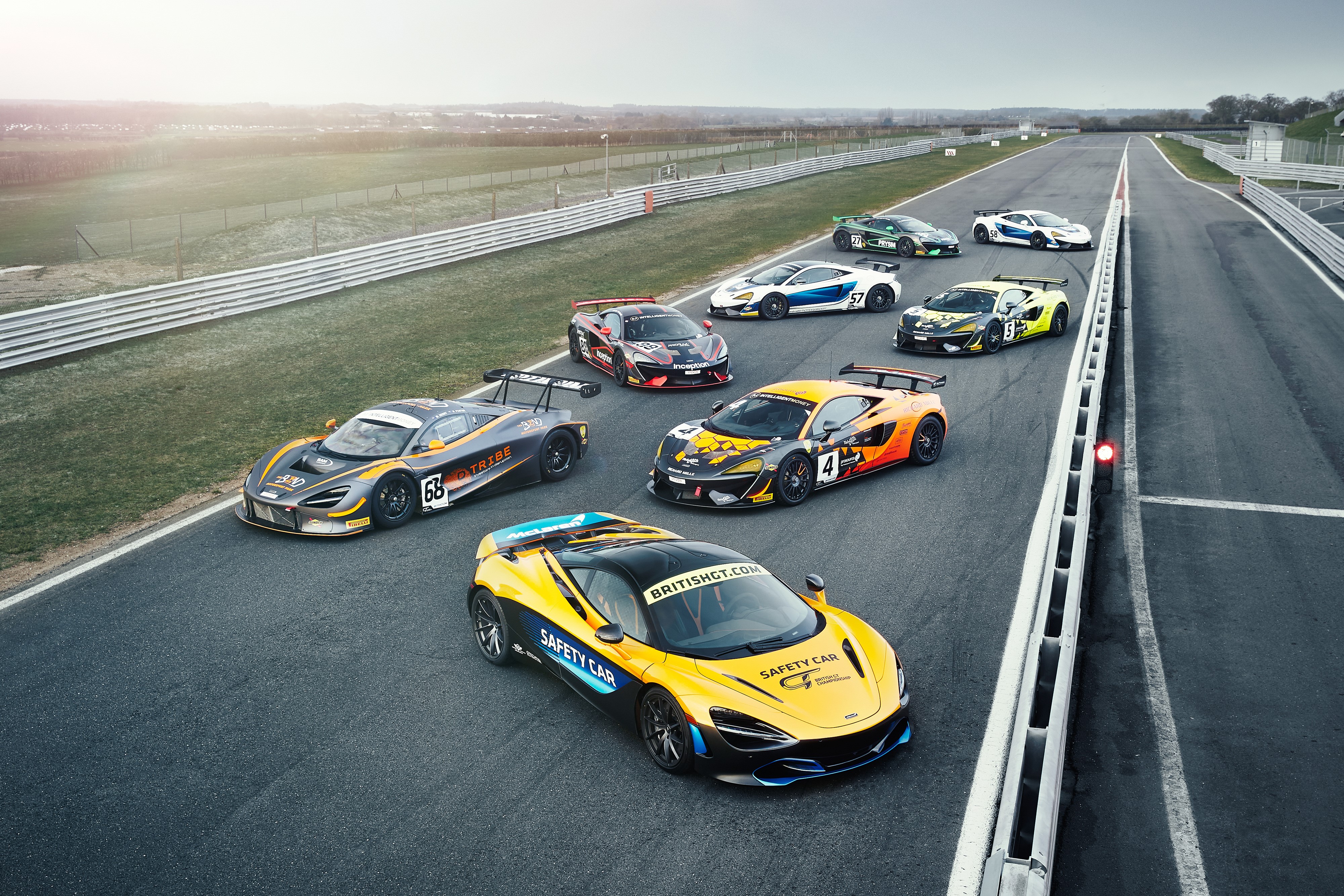Many McLaren cars on a race track HD Wallpaper