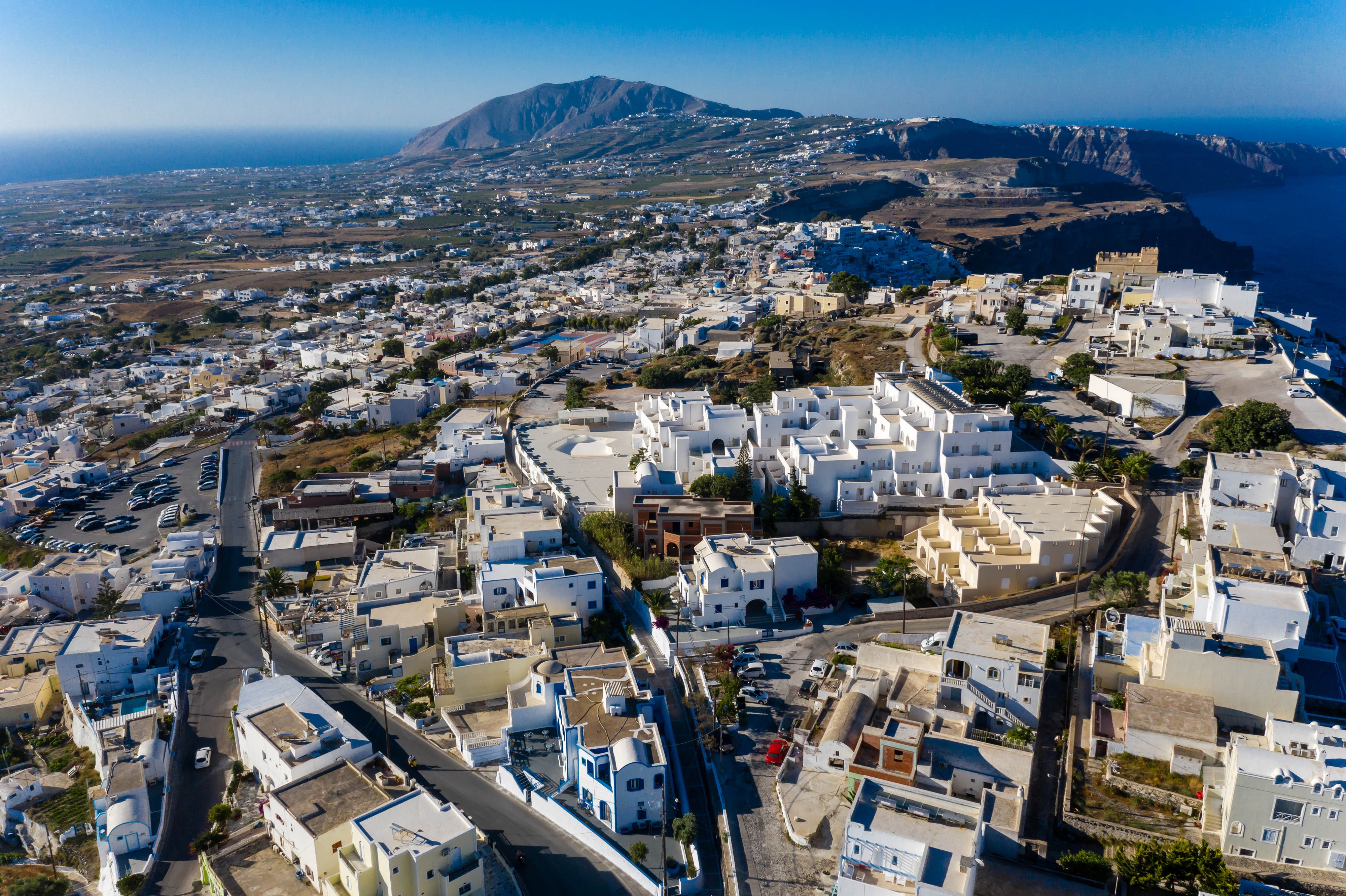 Aerial view of Thira, Greece with houses and streets HD Wallpaper