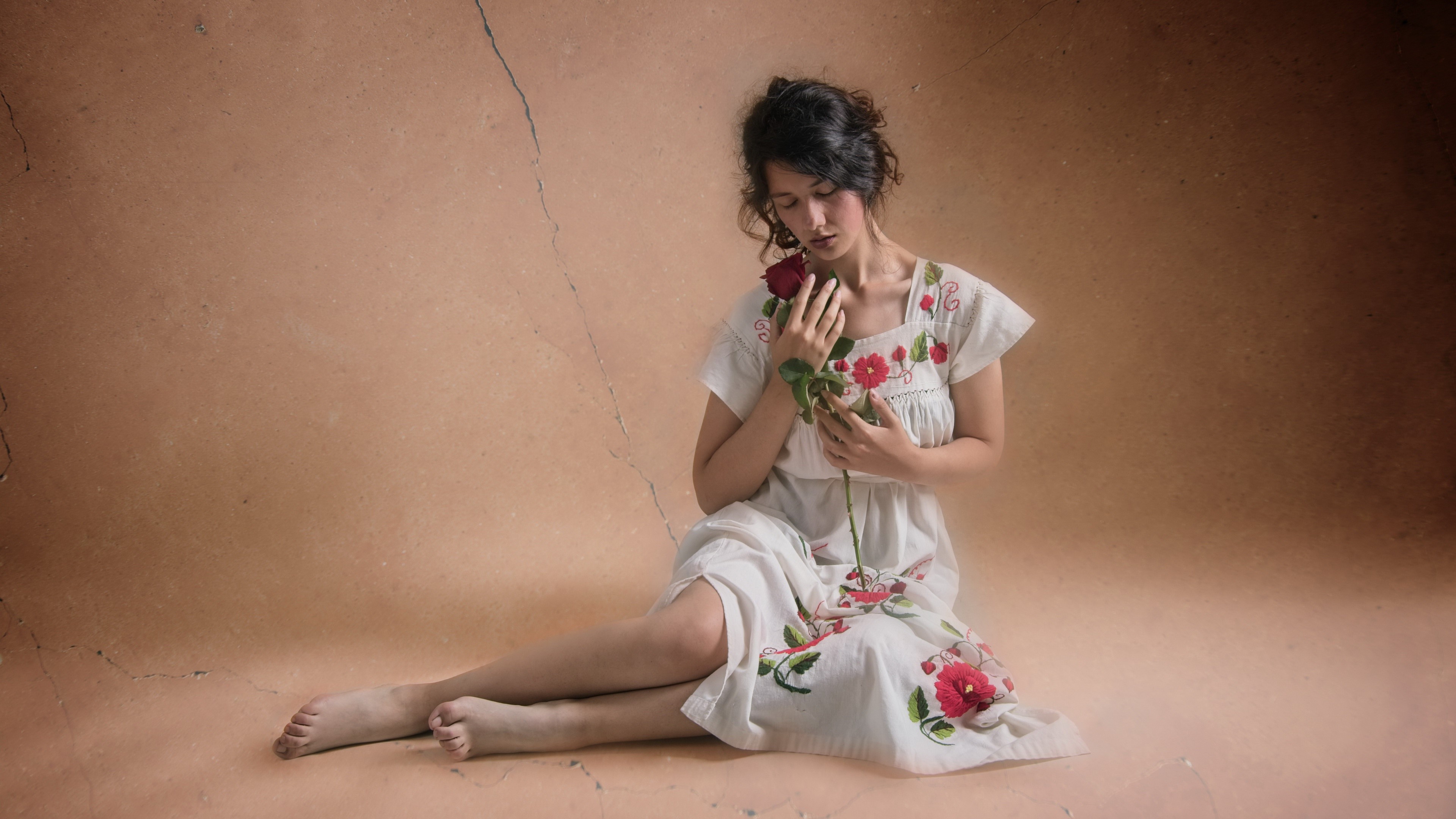 Woman in embroidered dress holding a rose HD Wallpaper