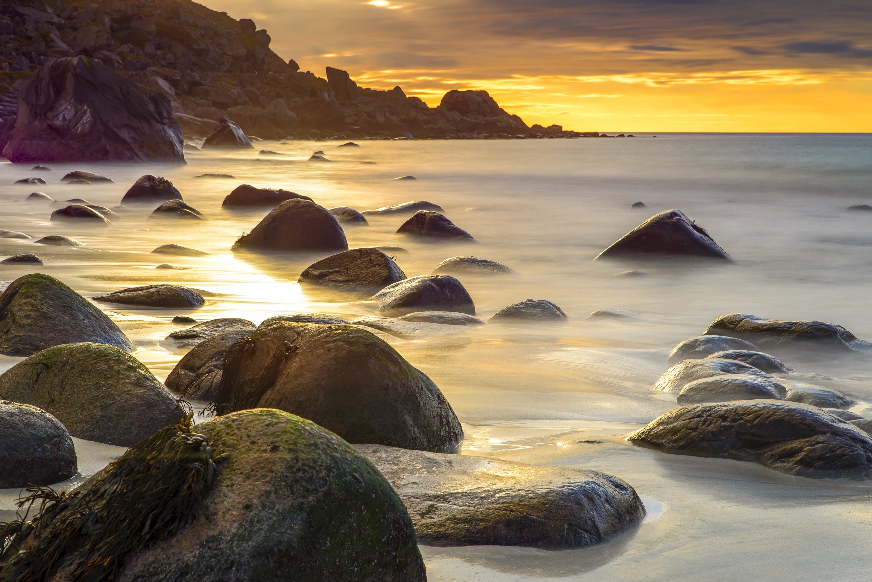 Stones on a beach at sunset in Norway HD Wallpaper