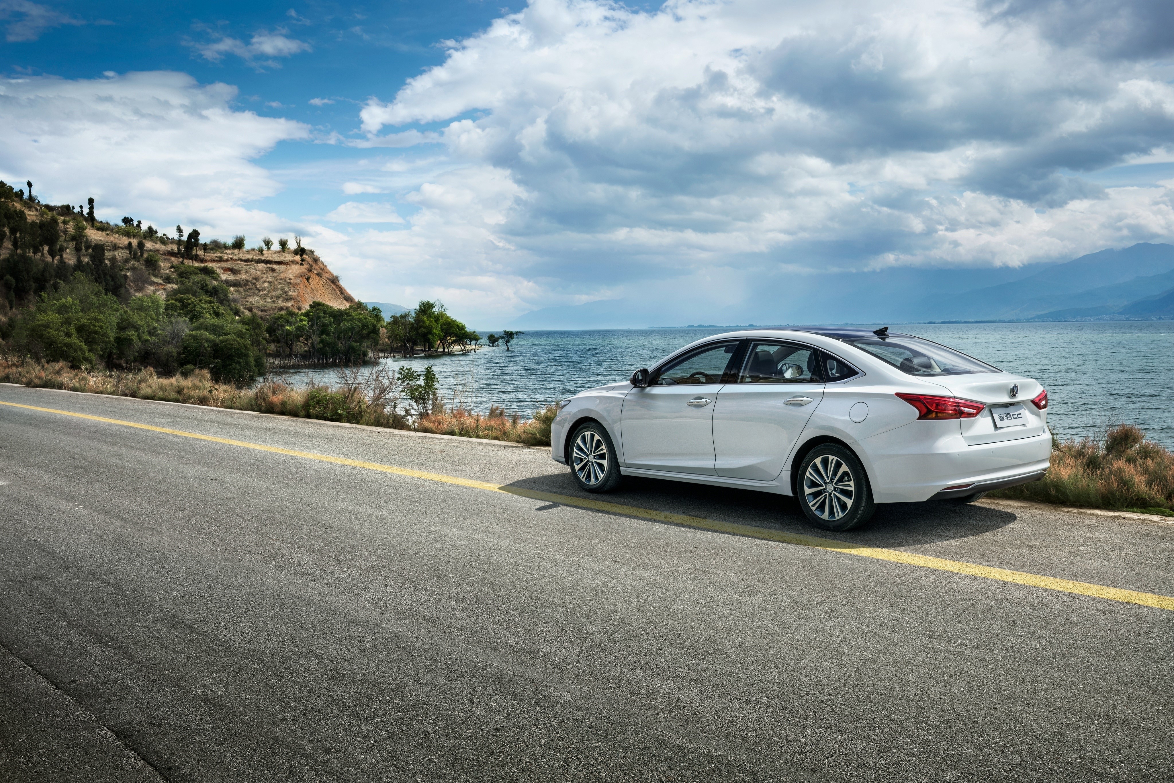 White Changan Sedan on a Coastal Road HD Wallpaper