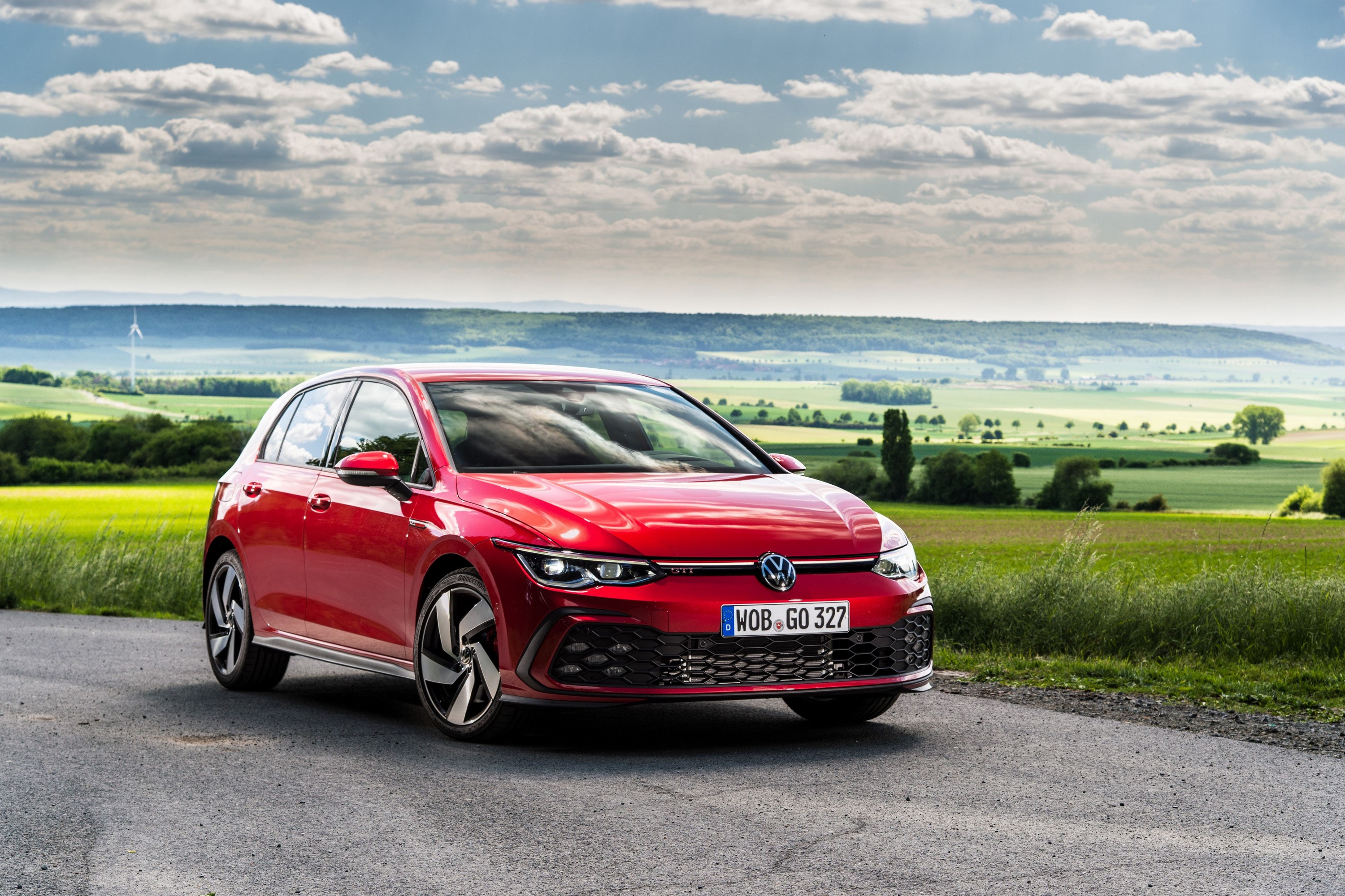 Red 2020 Volkswagen Golf GTI on a road HD Wallpaper