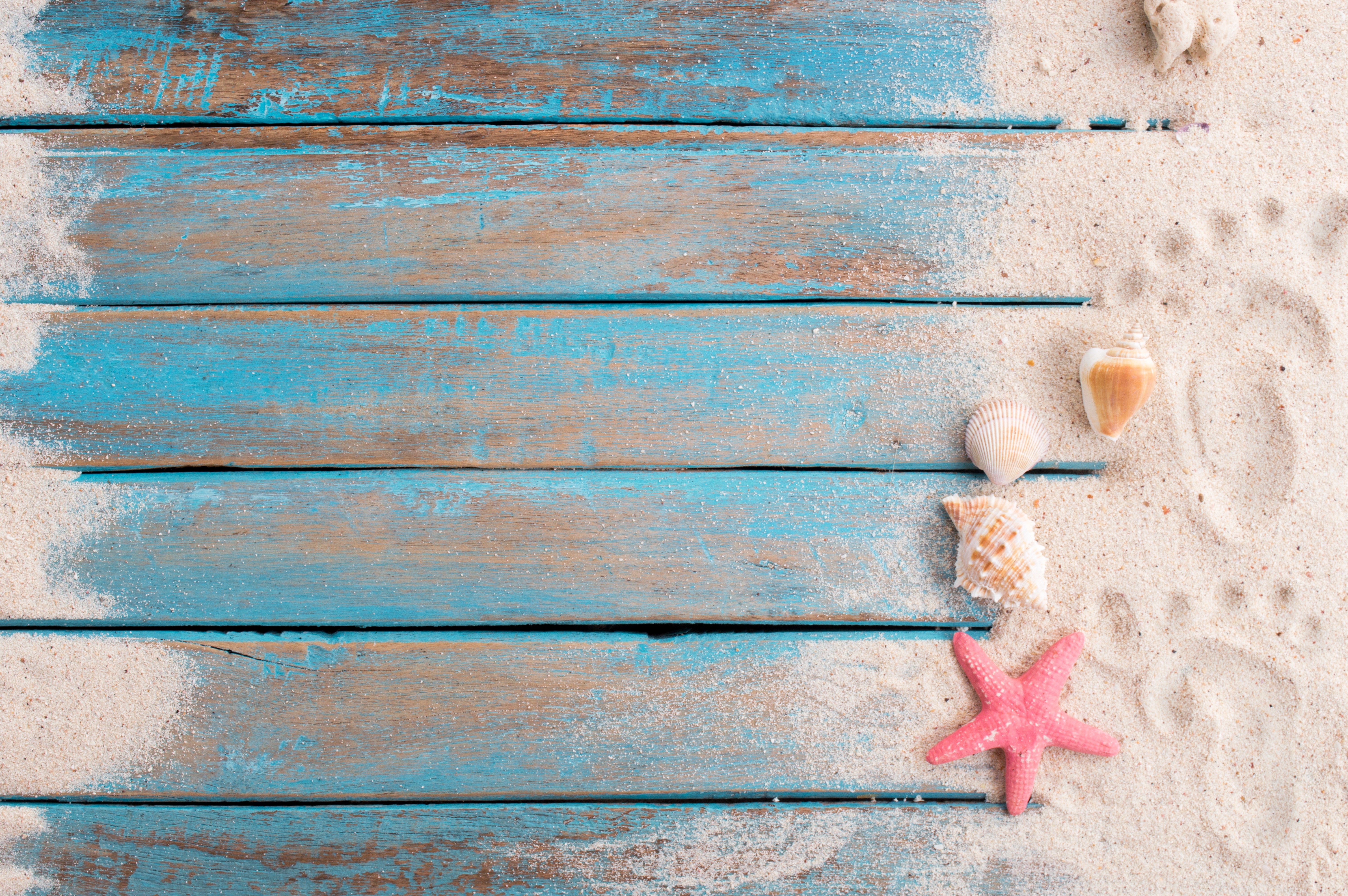 Beach Scene with Starfish, Shells, and Footprints on Wood Planks HD Wallpaper