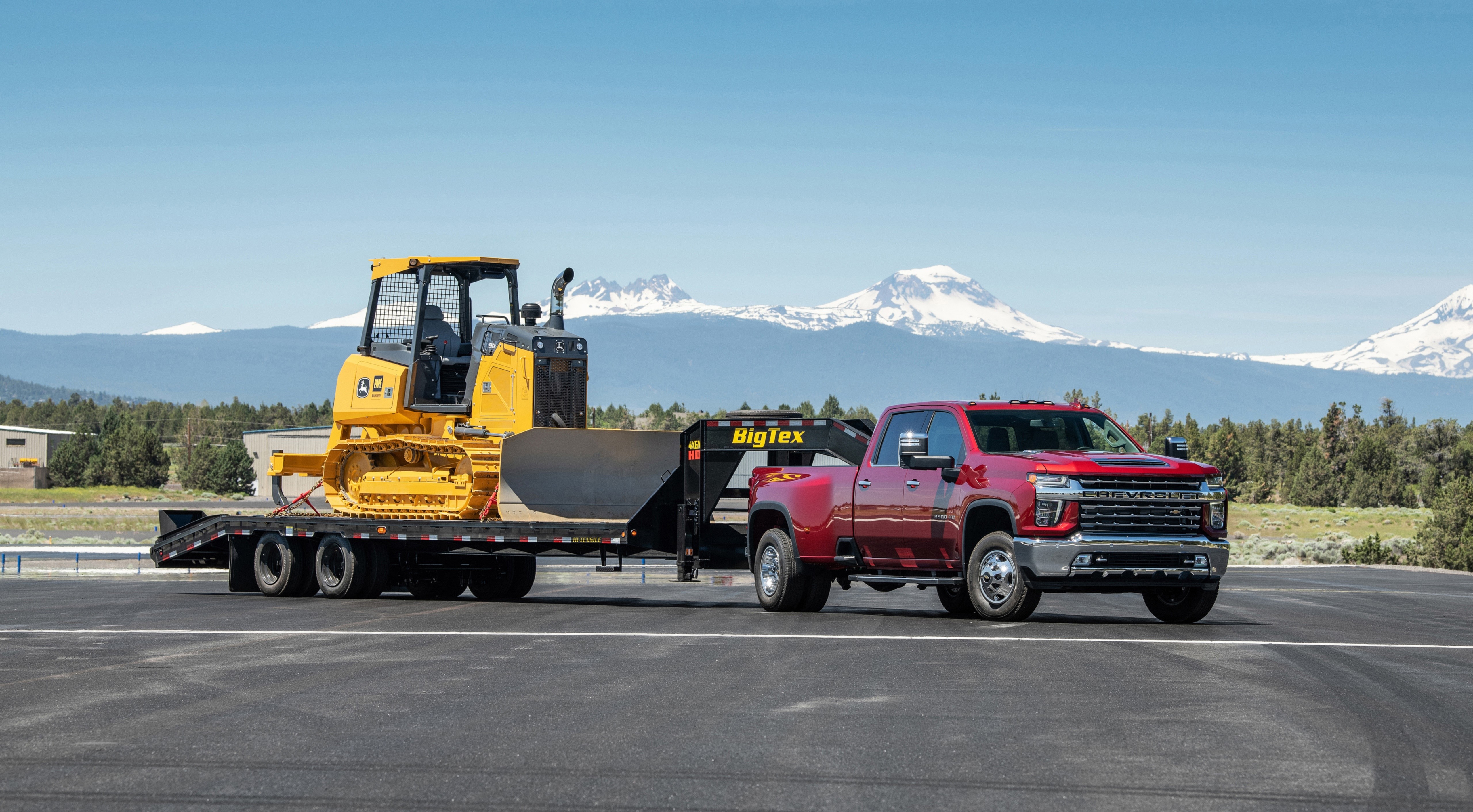 Red Chevrolet Silverado 3500 HD LTZ Crew Cab towing a bulldozer HD Wallpaper
