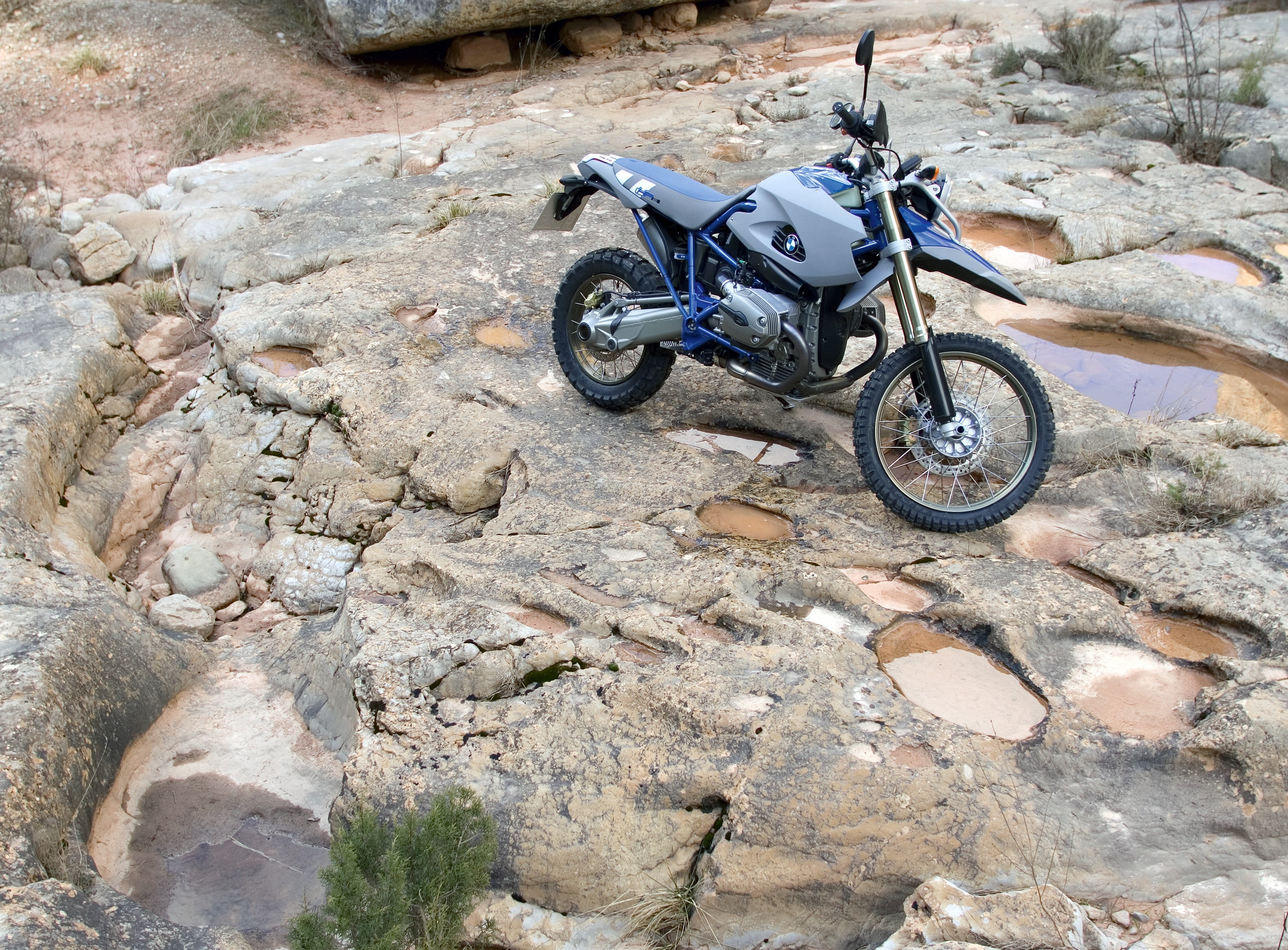 BMW HP2 Enduro motorcycle on rocky terrain HD Wallpaper
