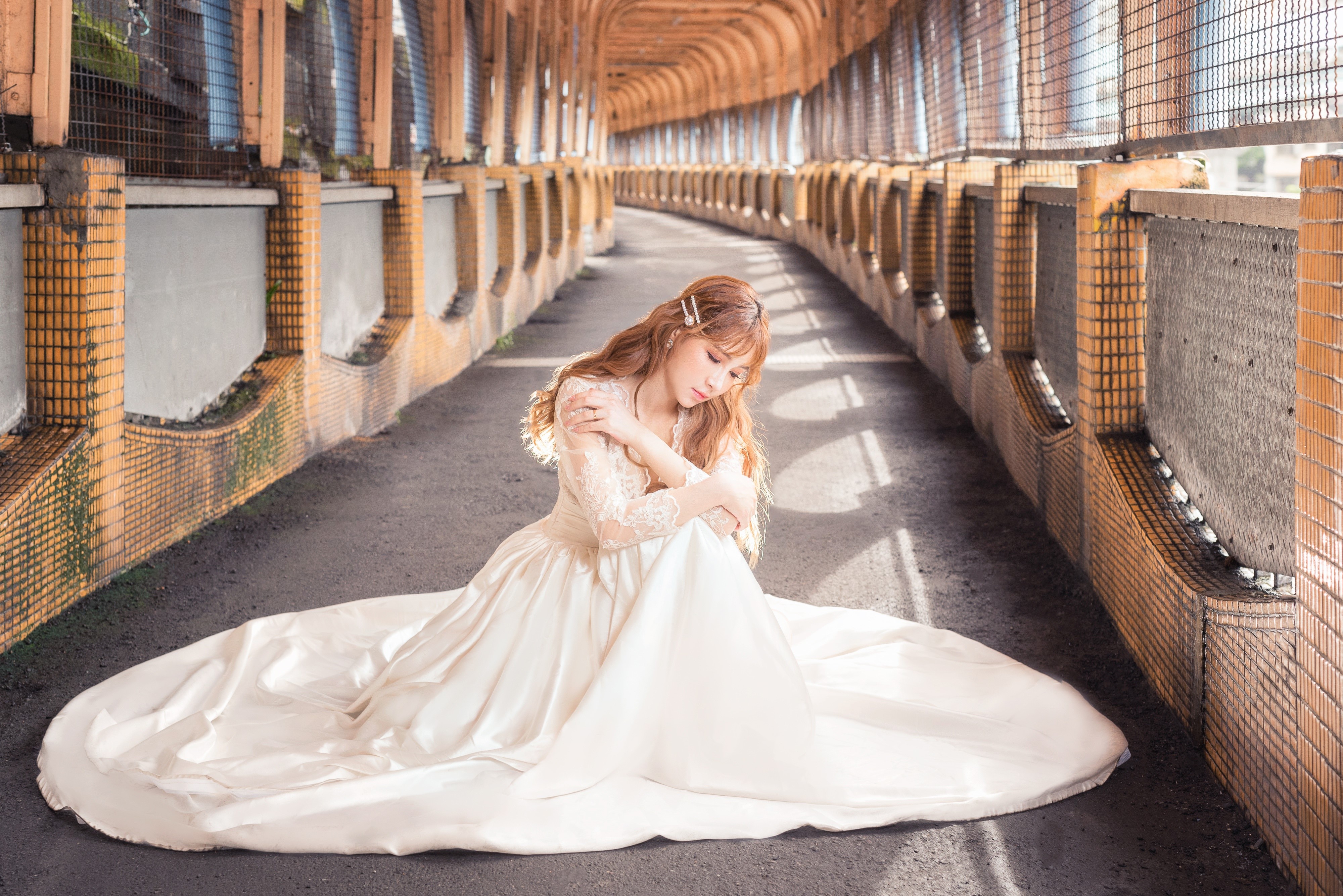 Asian woman in white dress sitting in a tunnel HD Wallpaper
