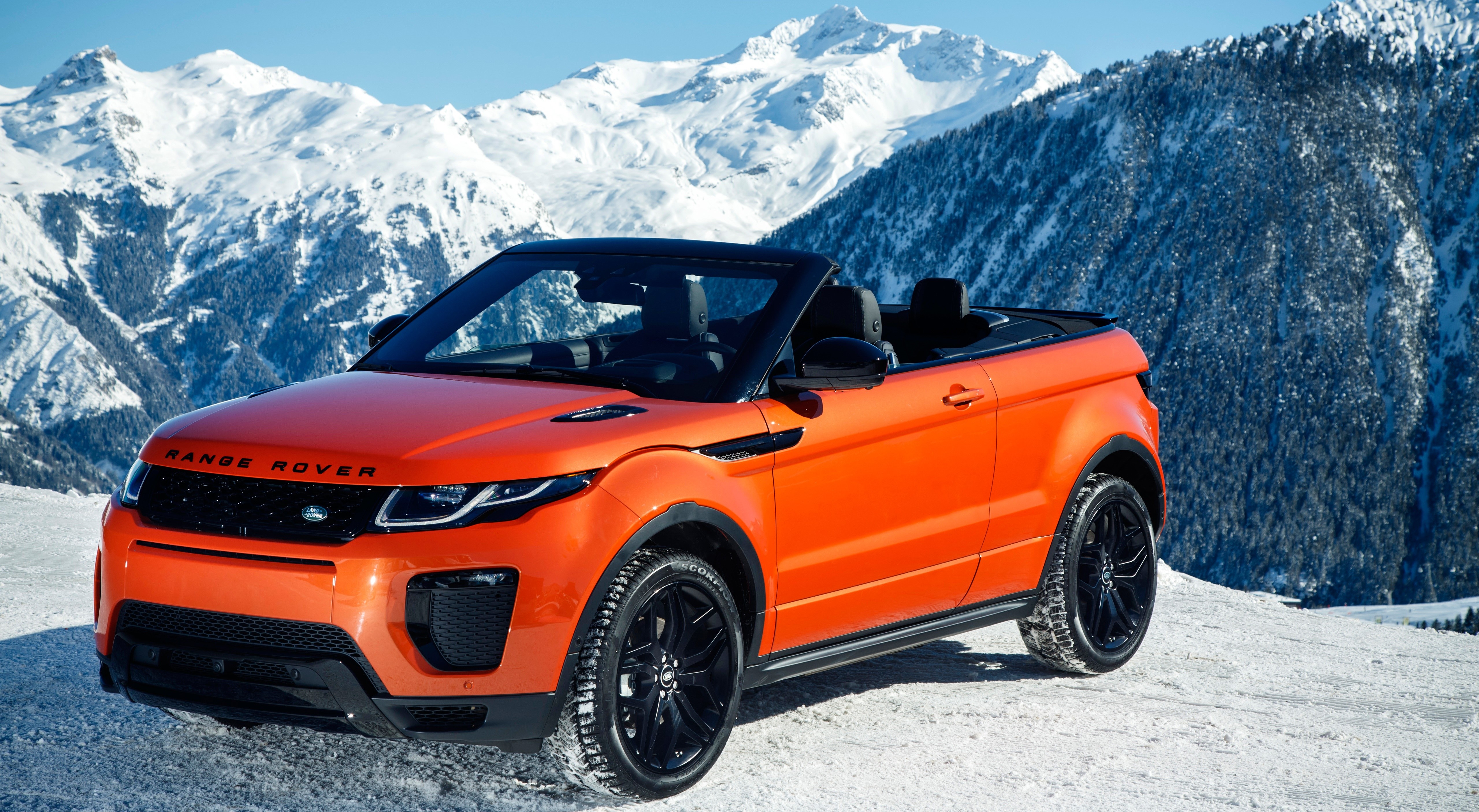 Orange Range Rover Evoque Convertible in Snowy Mountains HD Wallpaper