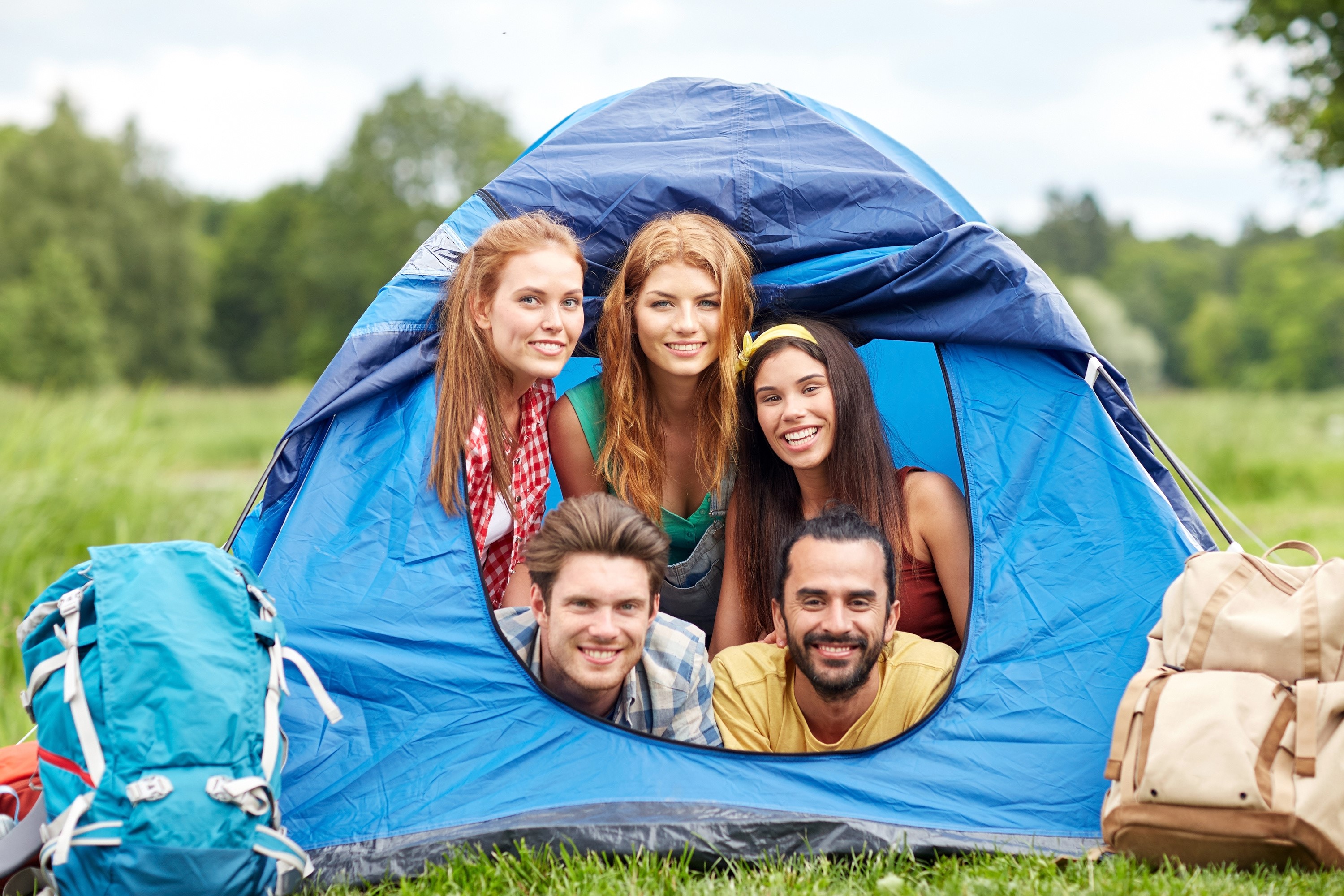Group of friends camping in a tent HD Wallpaper