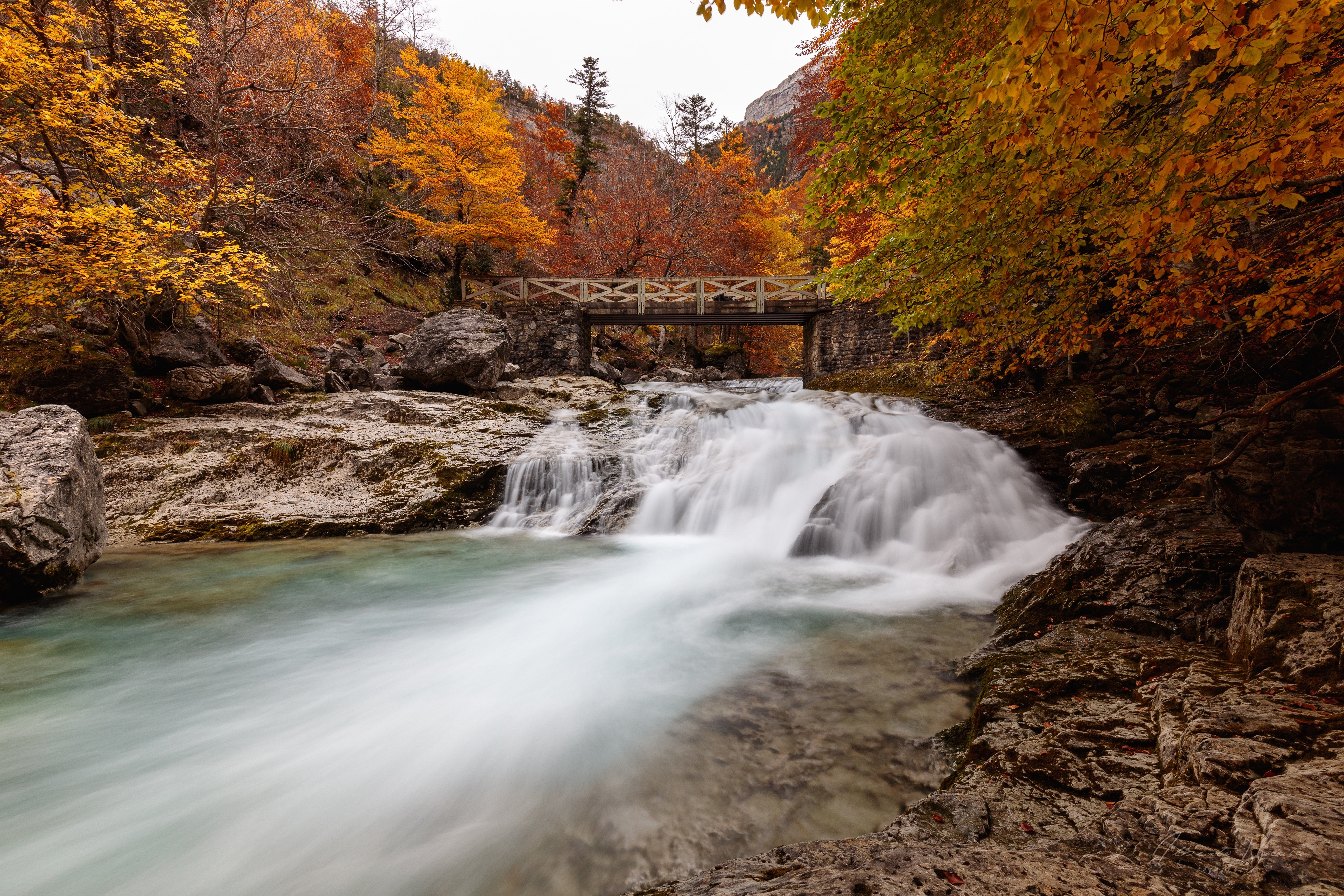 Autumn waterfall and bridge in Ordesa National Park, Spain HD Wallpaper