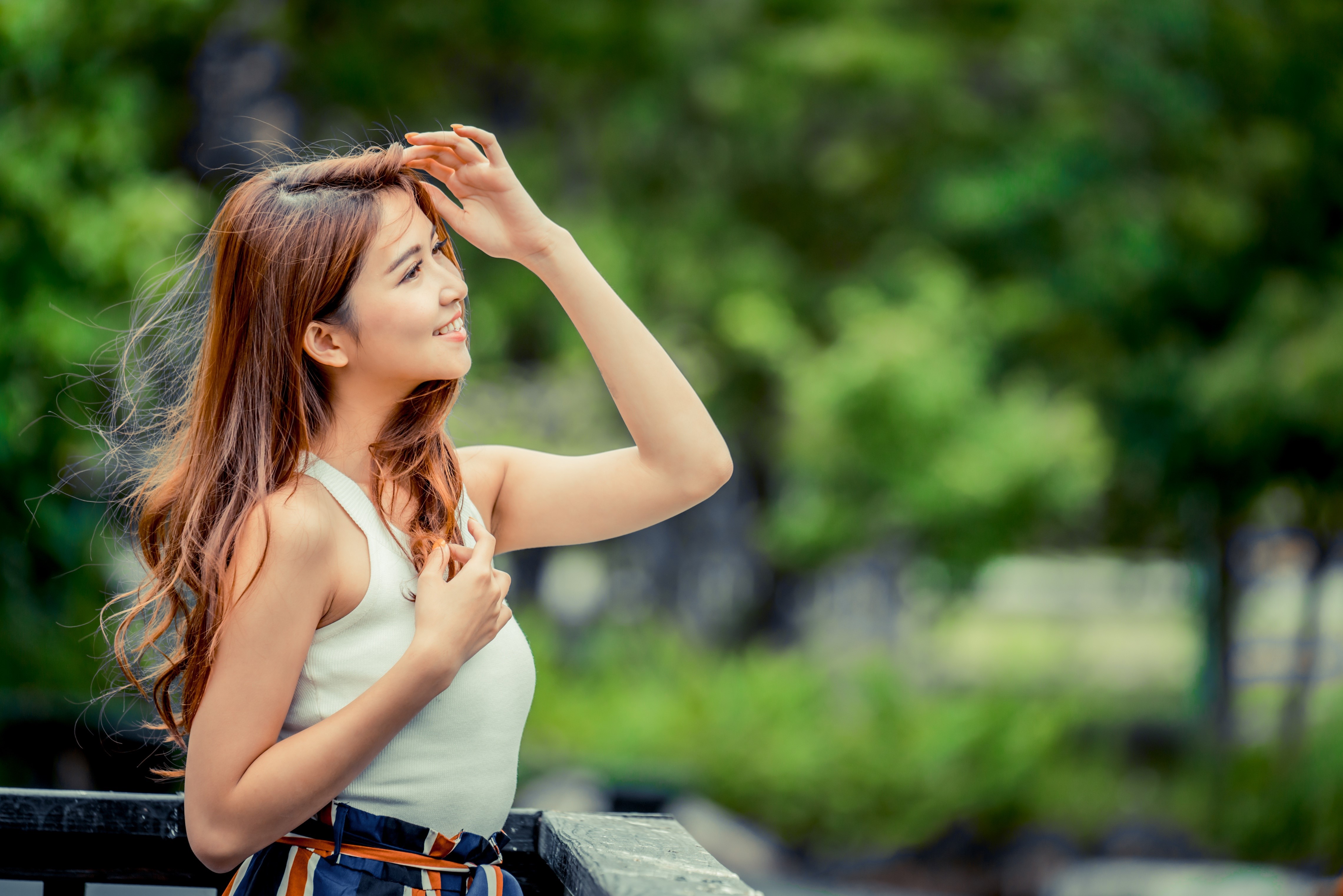 Asian woman with brown hair smiling outdoors HD Wallpaper