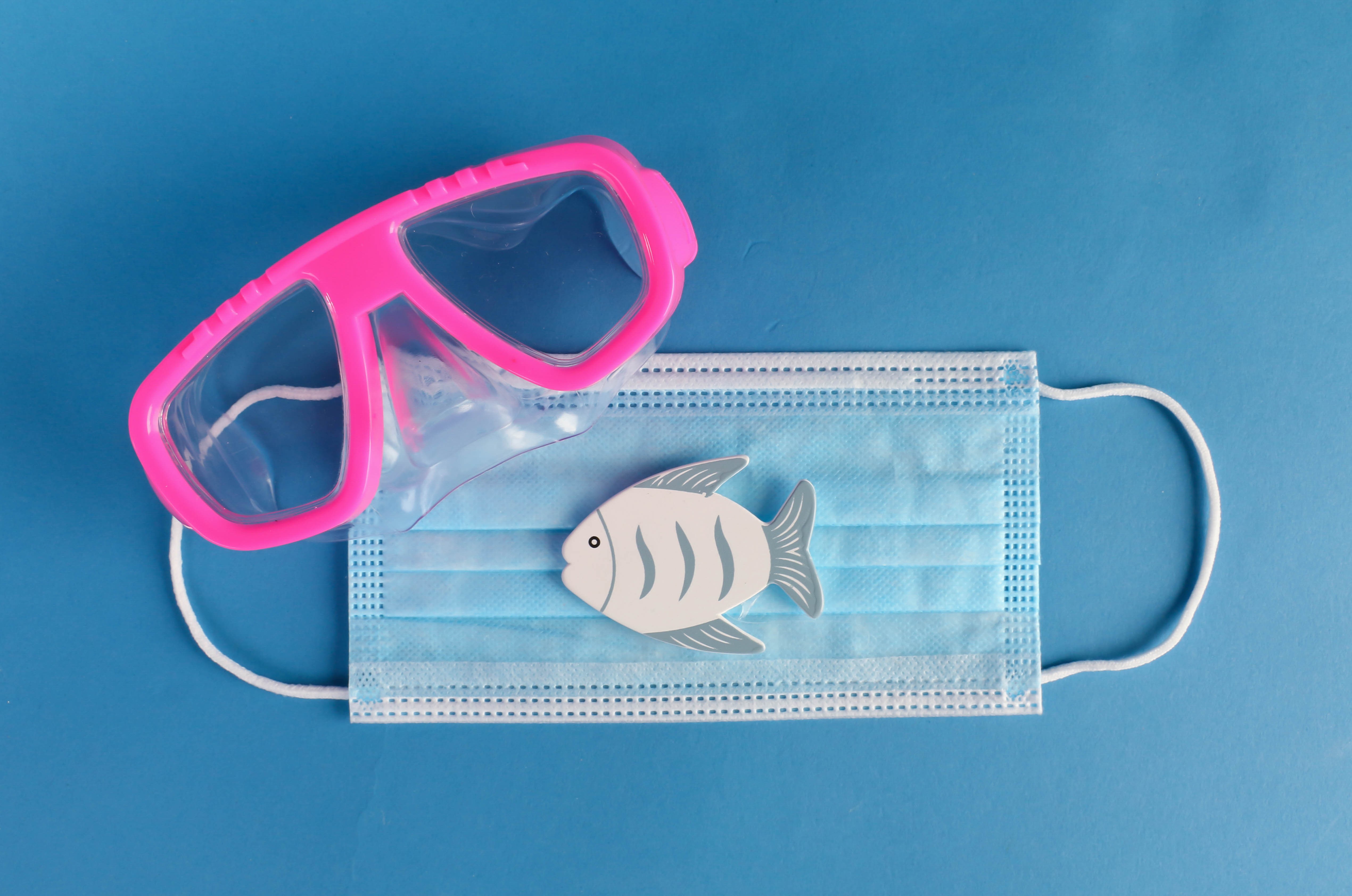 Pink diving mask and fish on a blue background HD Wallpaper