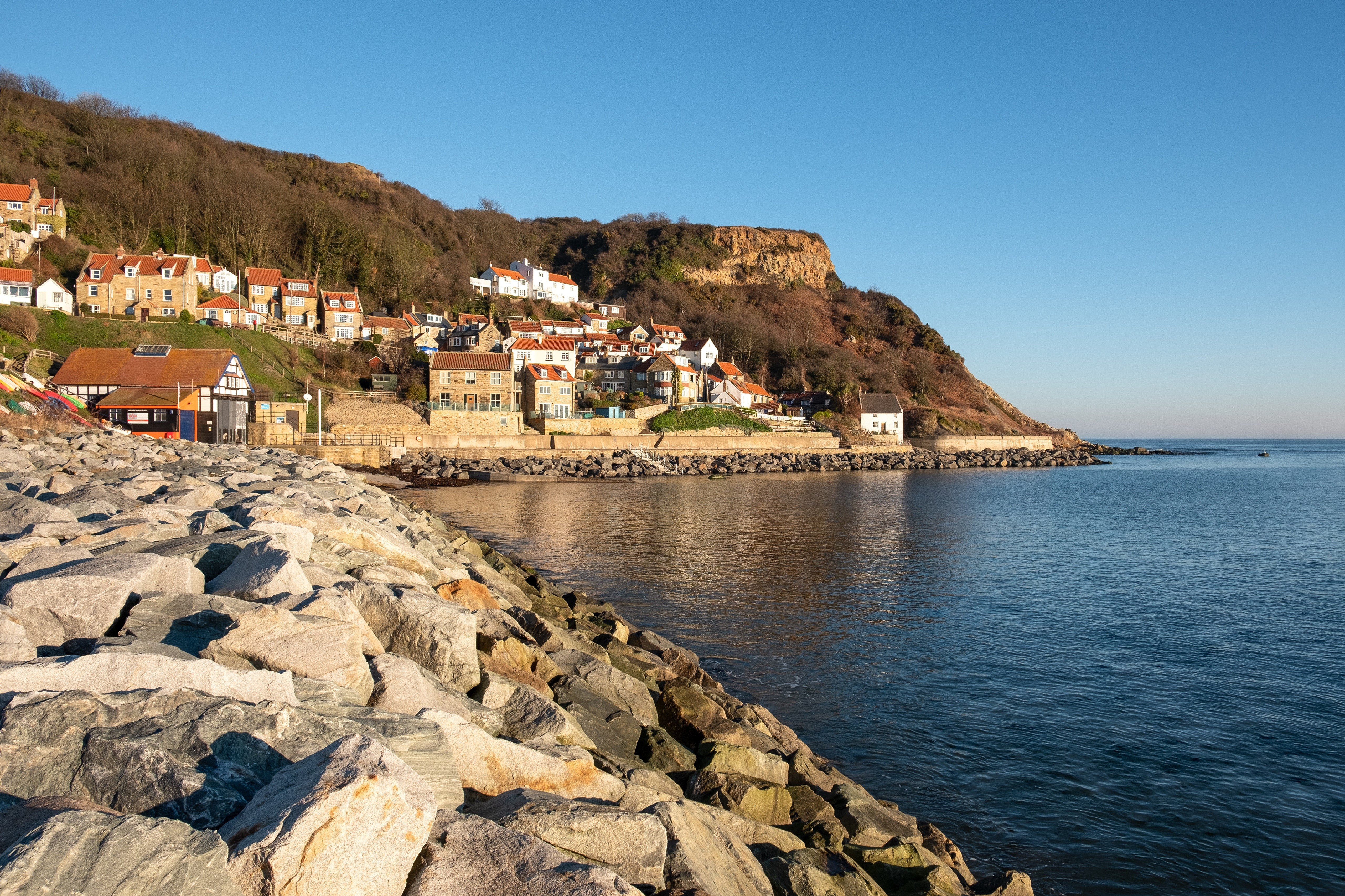 Runswick Bay, Yorkshire Coastline with Houses and Sea HD Wallpaper