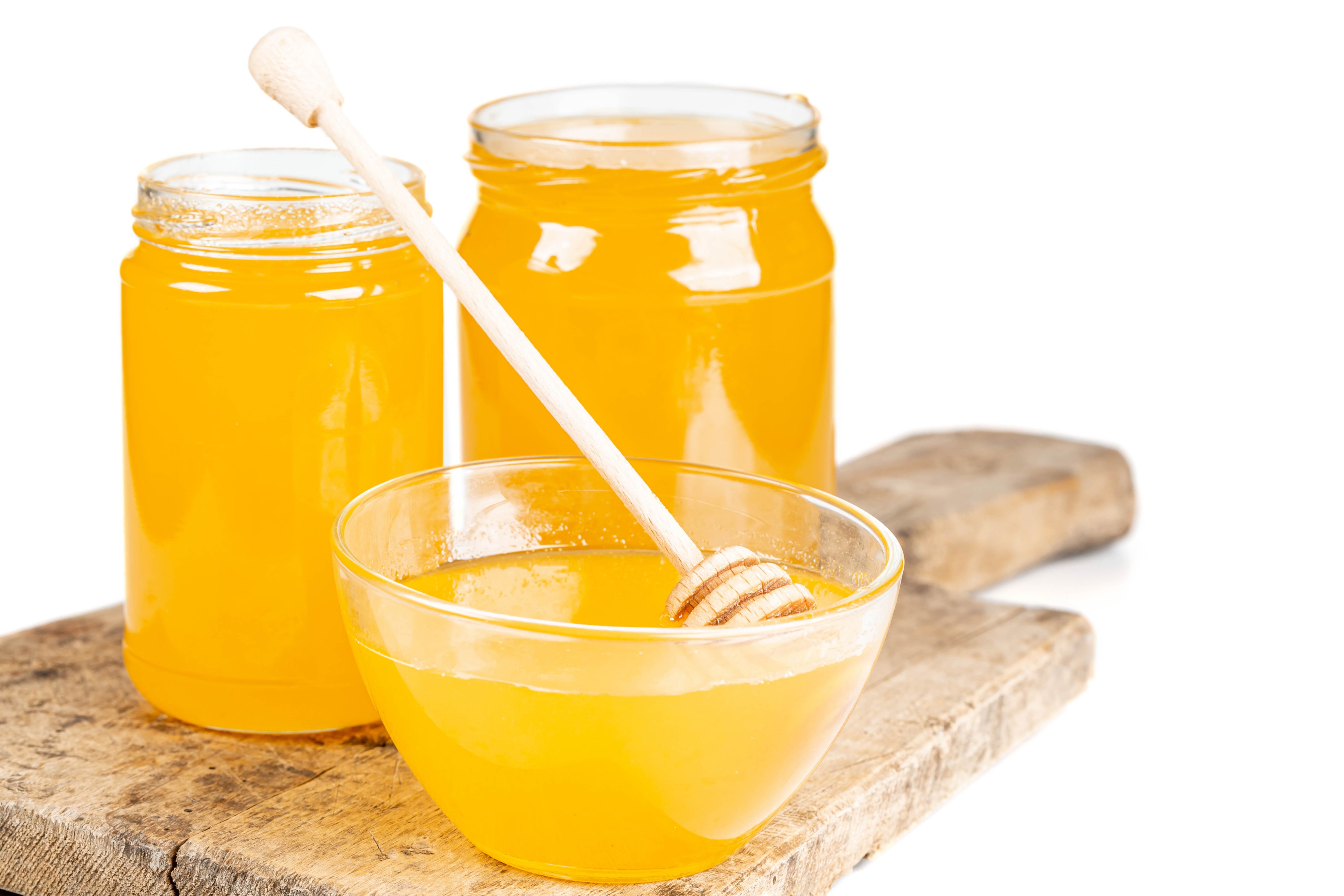 Honey in jars and bowl on cutting board HD Wallpaper