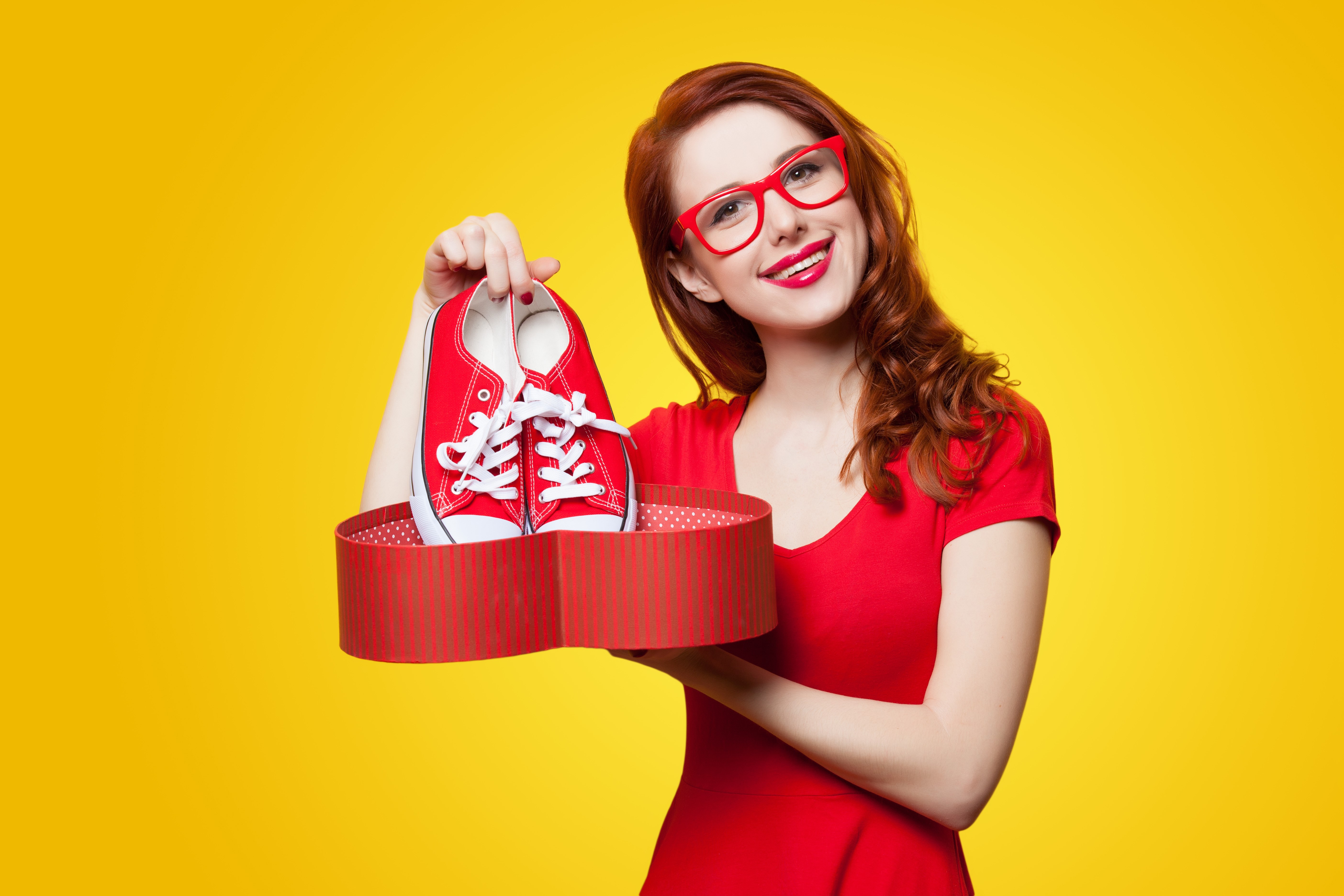 Redhead girl with red glasses holding red shoes in heart box HD Wallpaper