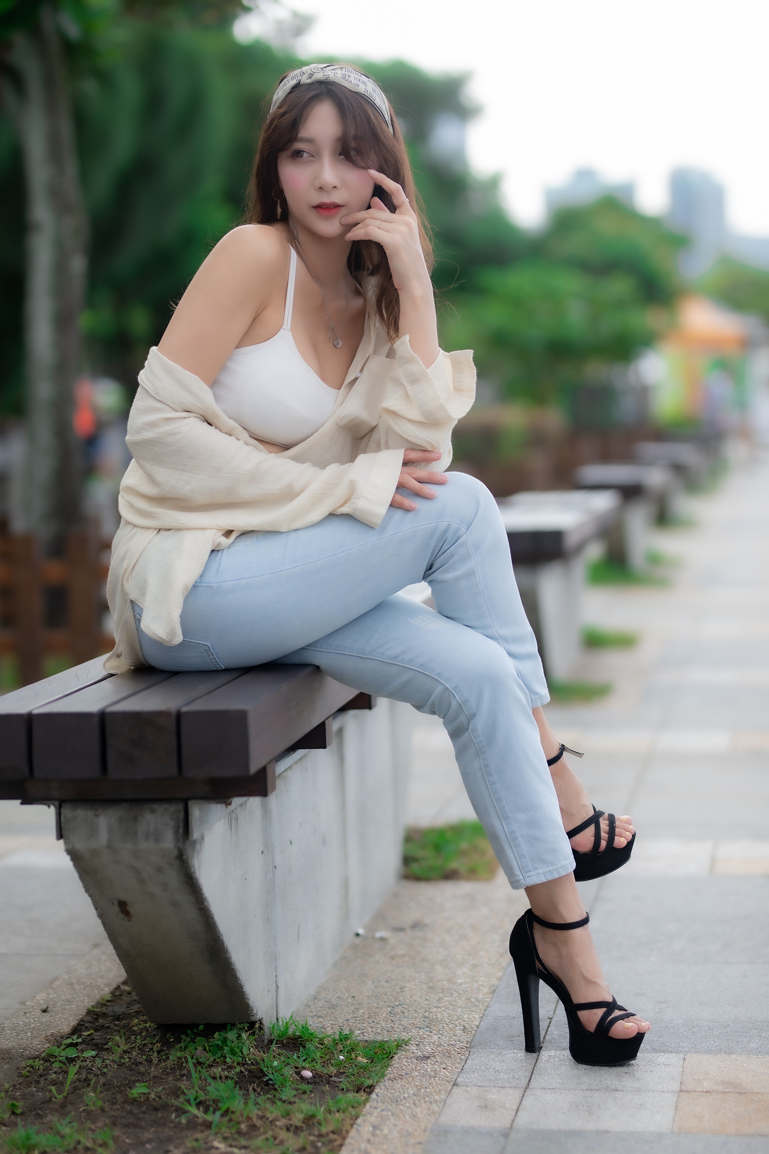 Asian woman sitting on a bench HD Phone Wallpaper