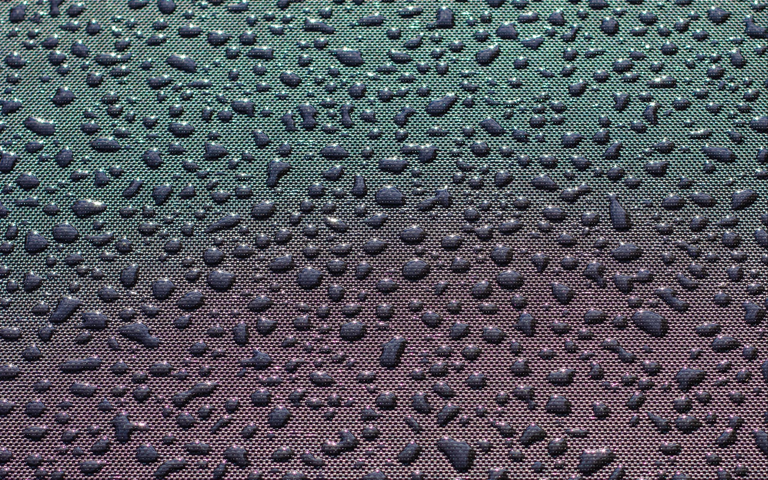 Water drops on a textured surface HD Wallpaper