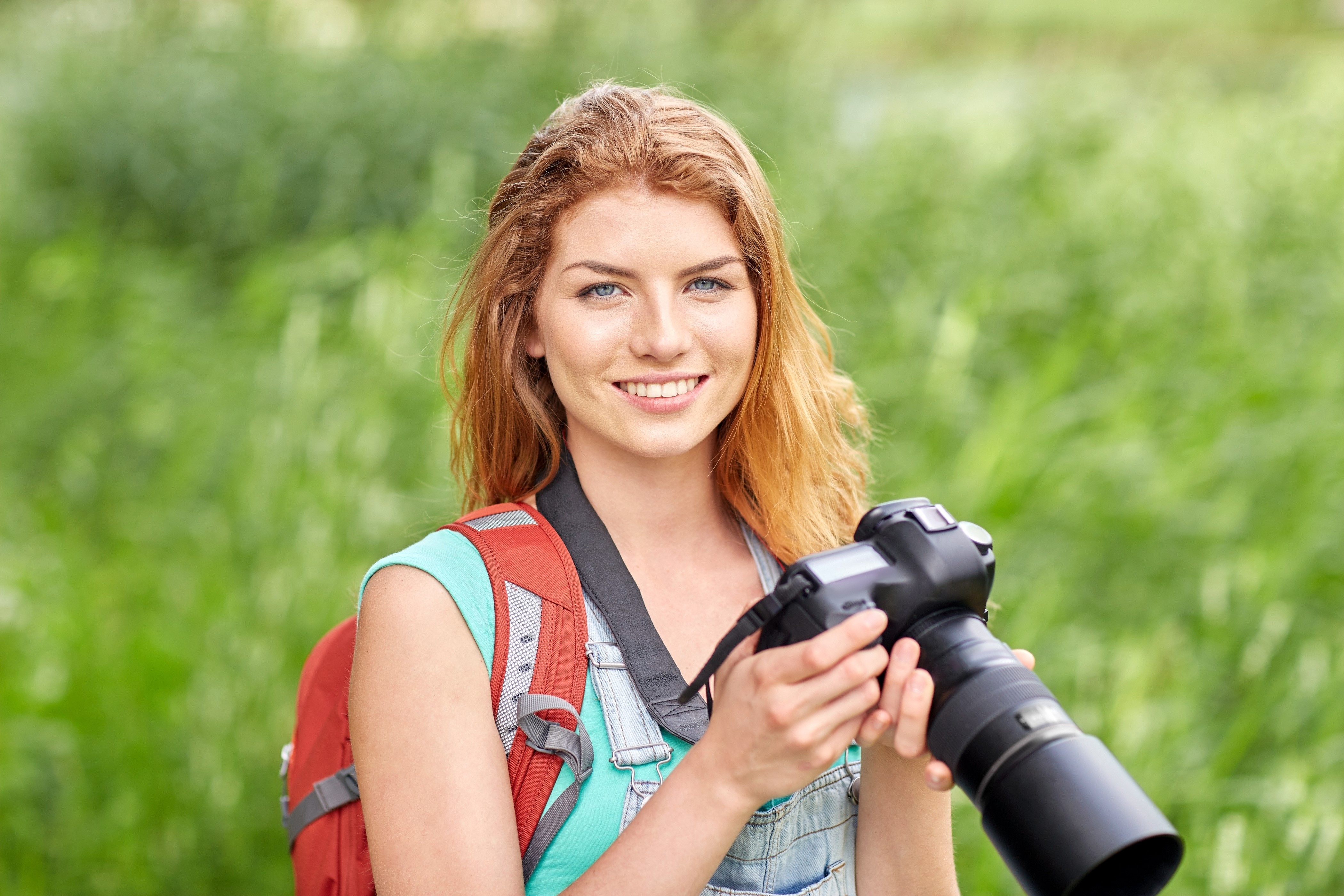 Redhead girl with camera and backpack HD Wallpaper