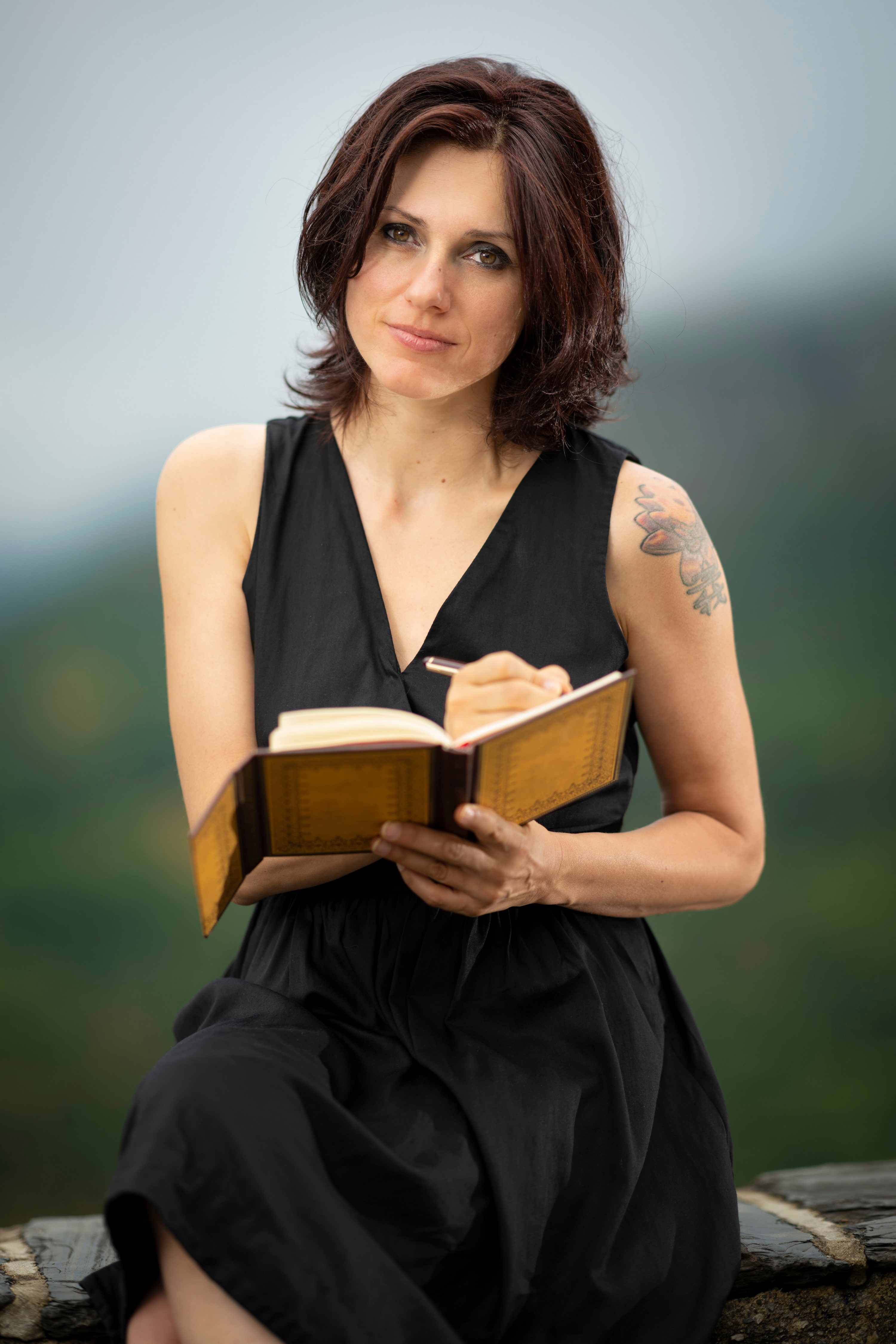 Woman writing in a book outdoors HD Phone Wallpaper