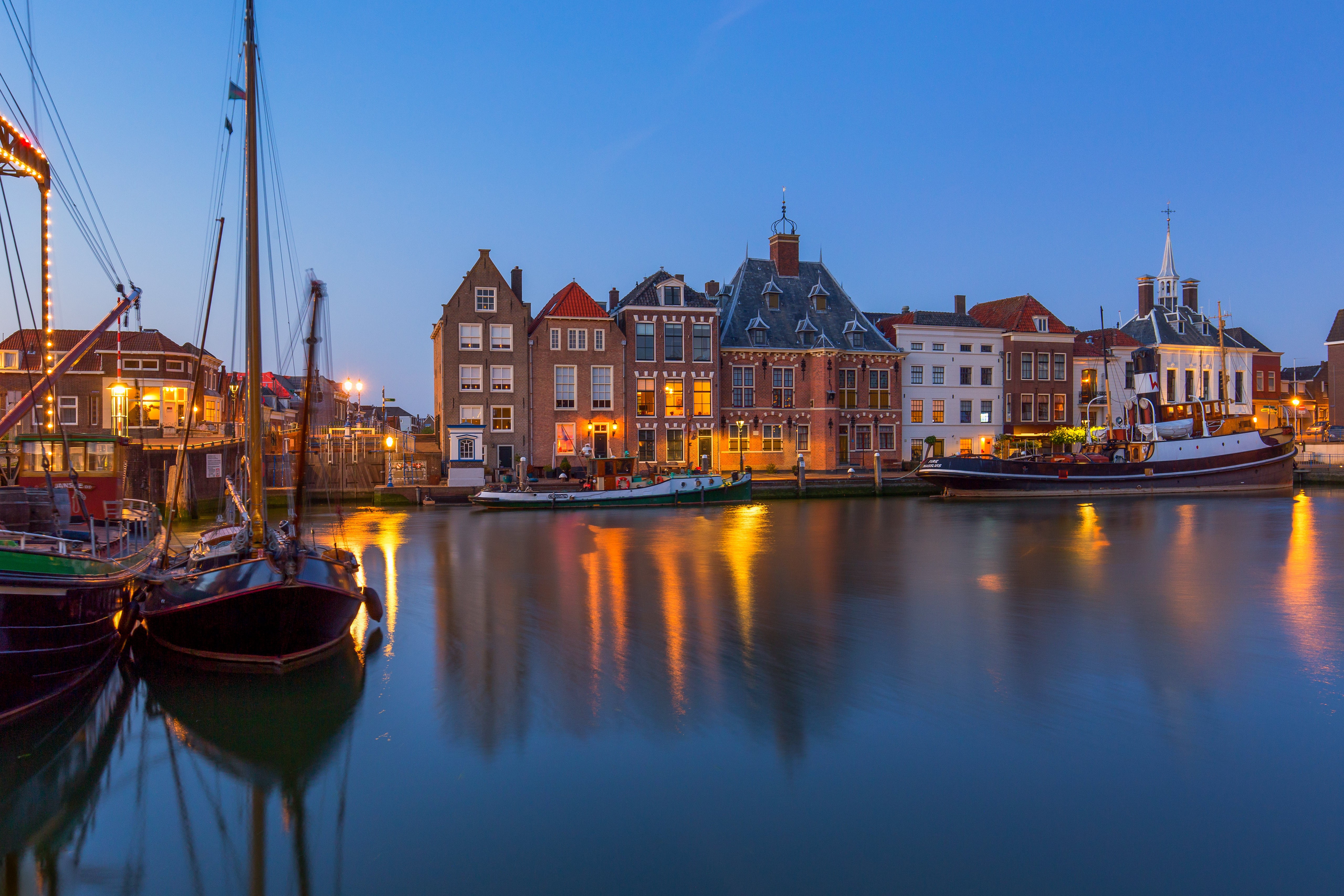 Maassluis, Netherlands waterfront with boats and houses at dusk HD Wallpaper